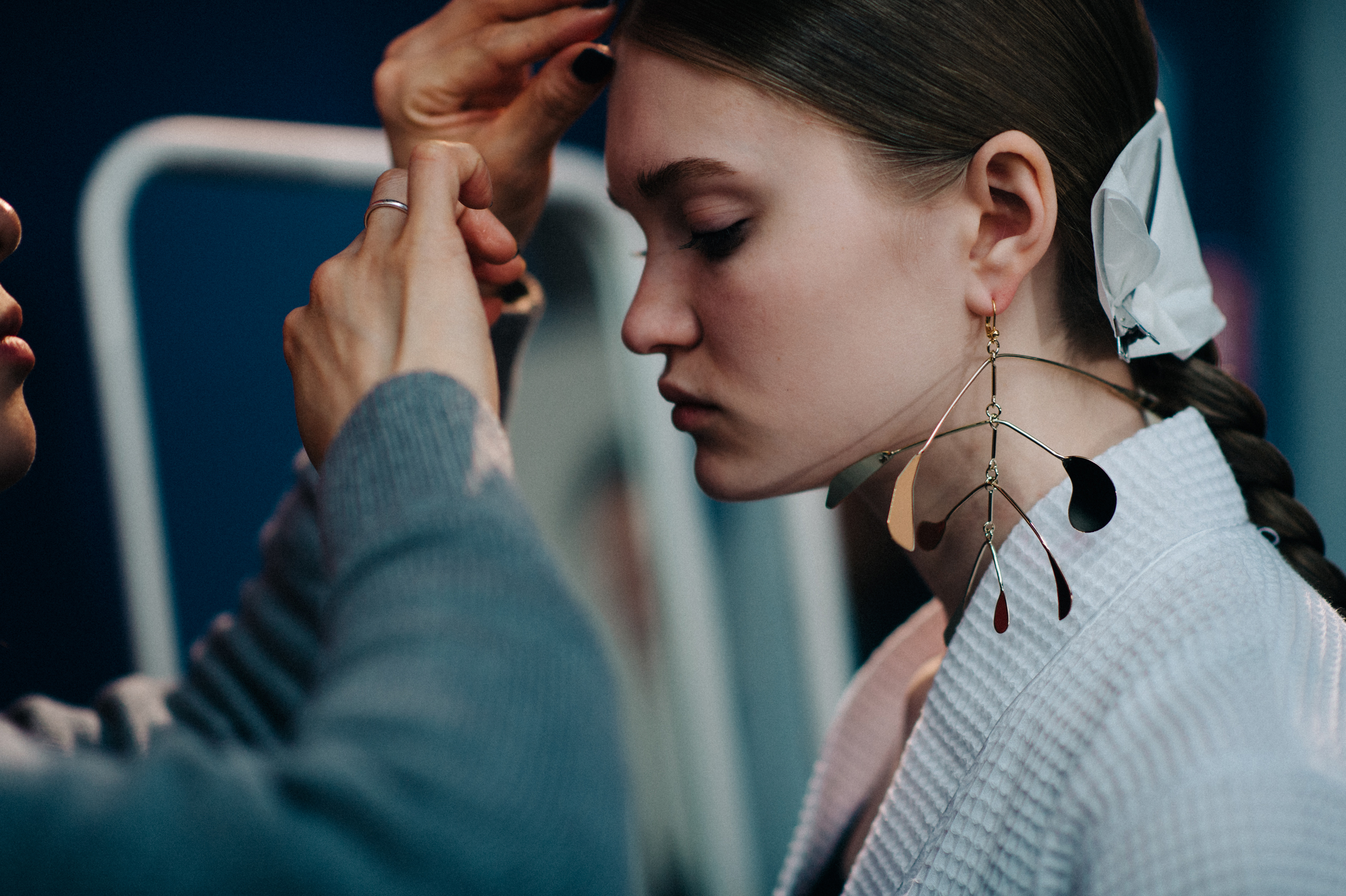 Model wearing golden mono earring