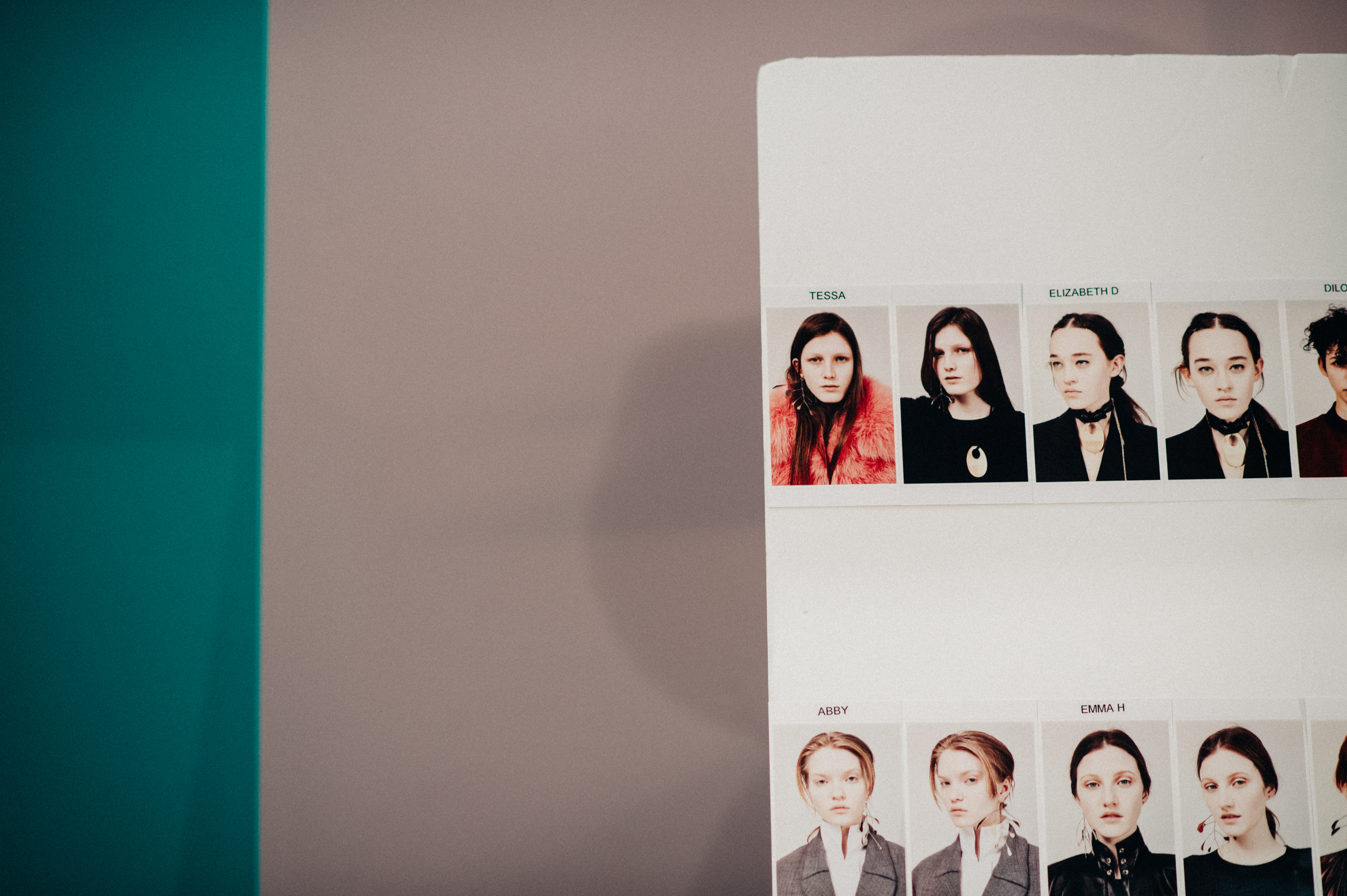 Board with model faces polaroids