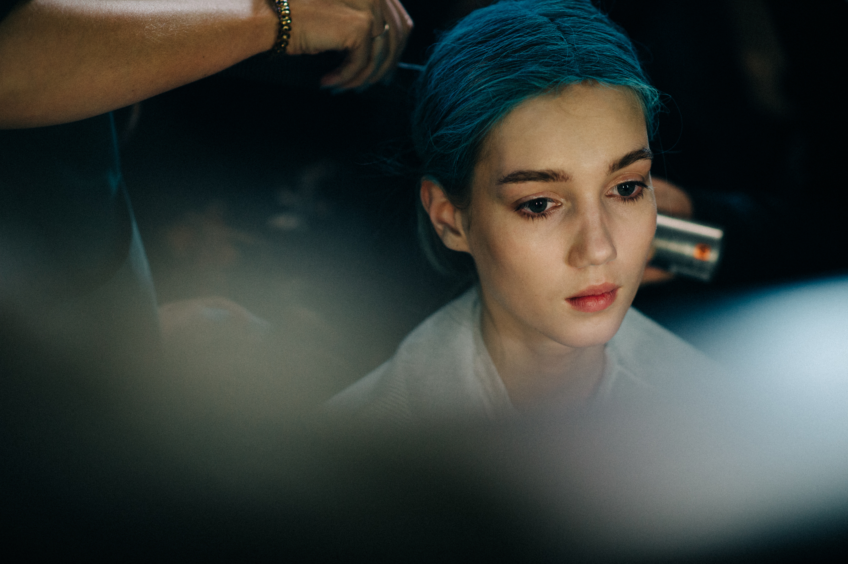 Model getting hair dyed blue