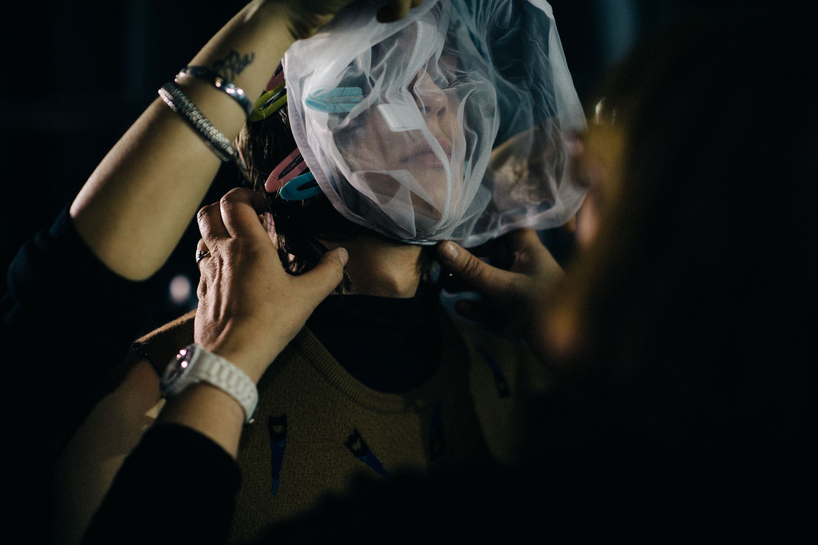 Male model getting dressed before show