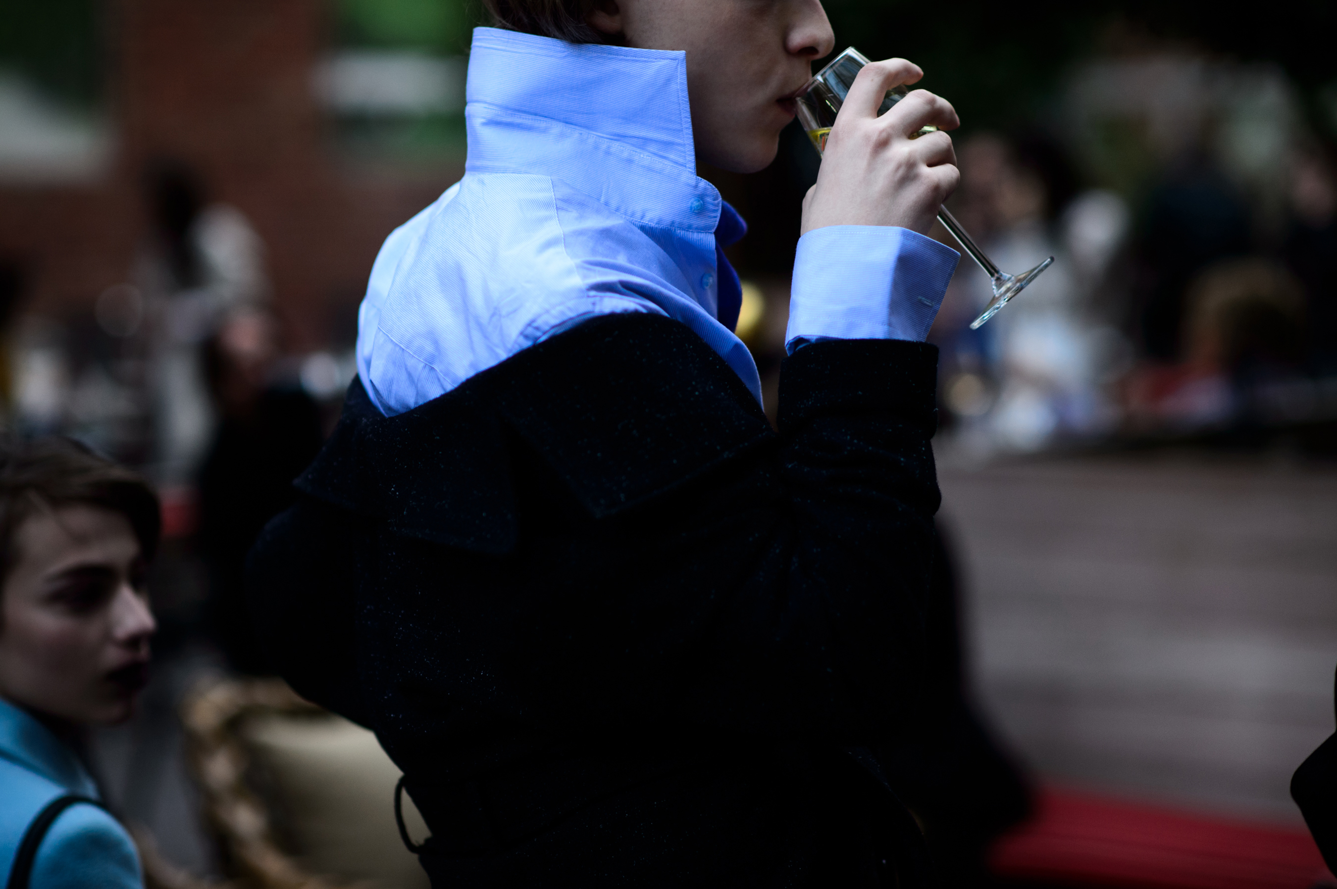 Boy wearing shirt drinking wine