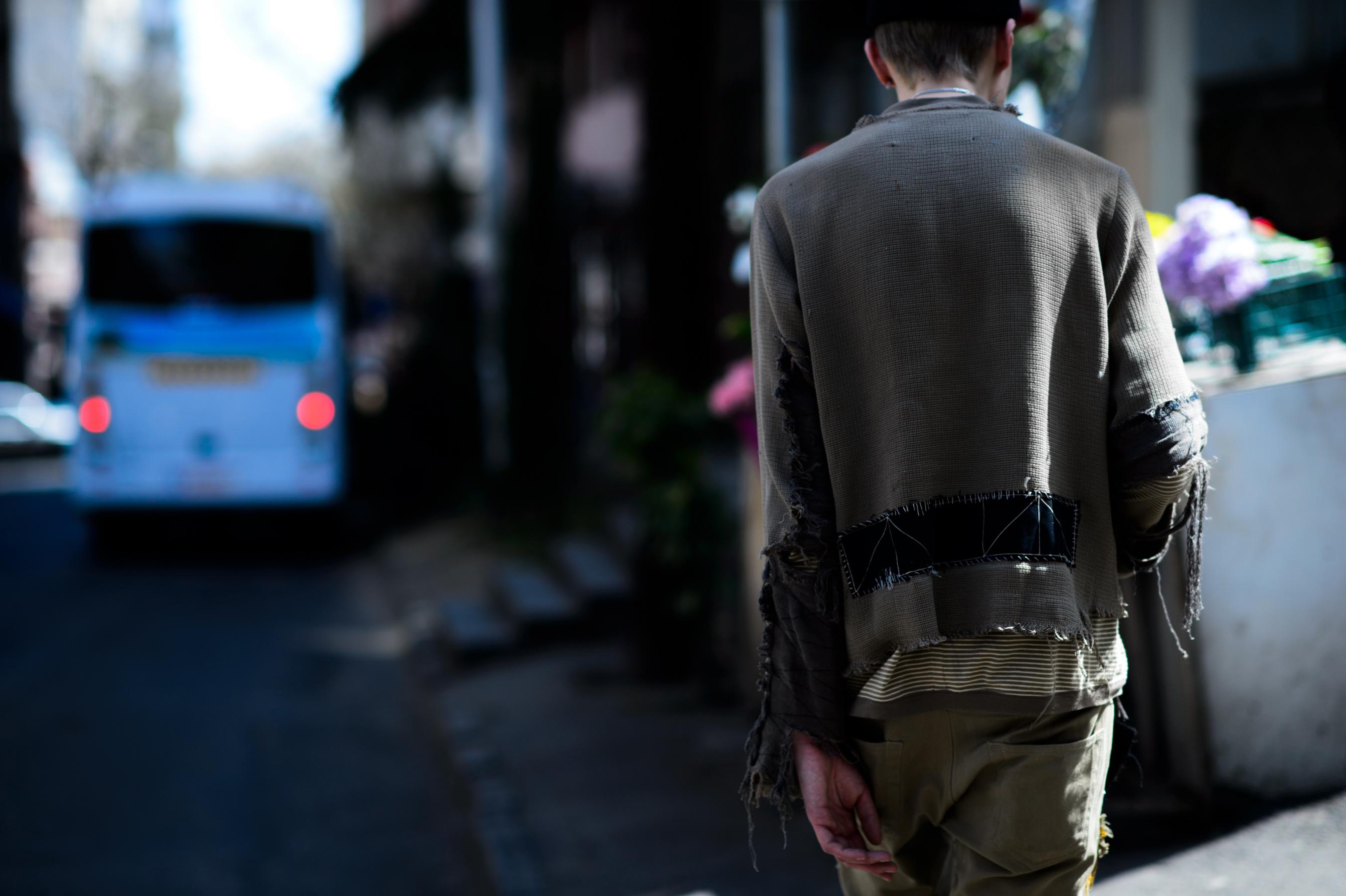 Man wearing ripped sand color outfit
