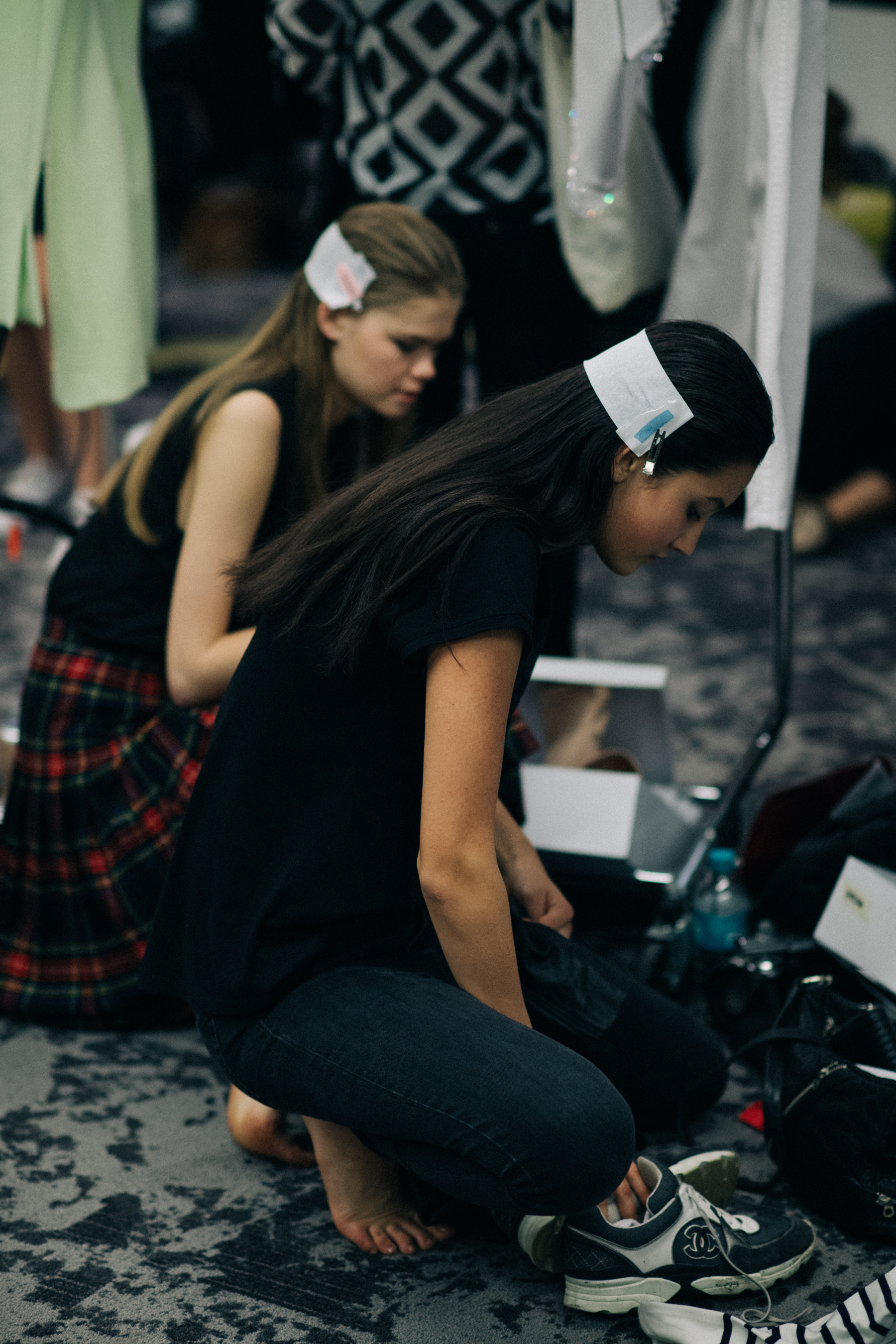 Two models with long clipped hair