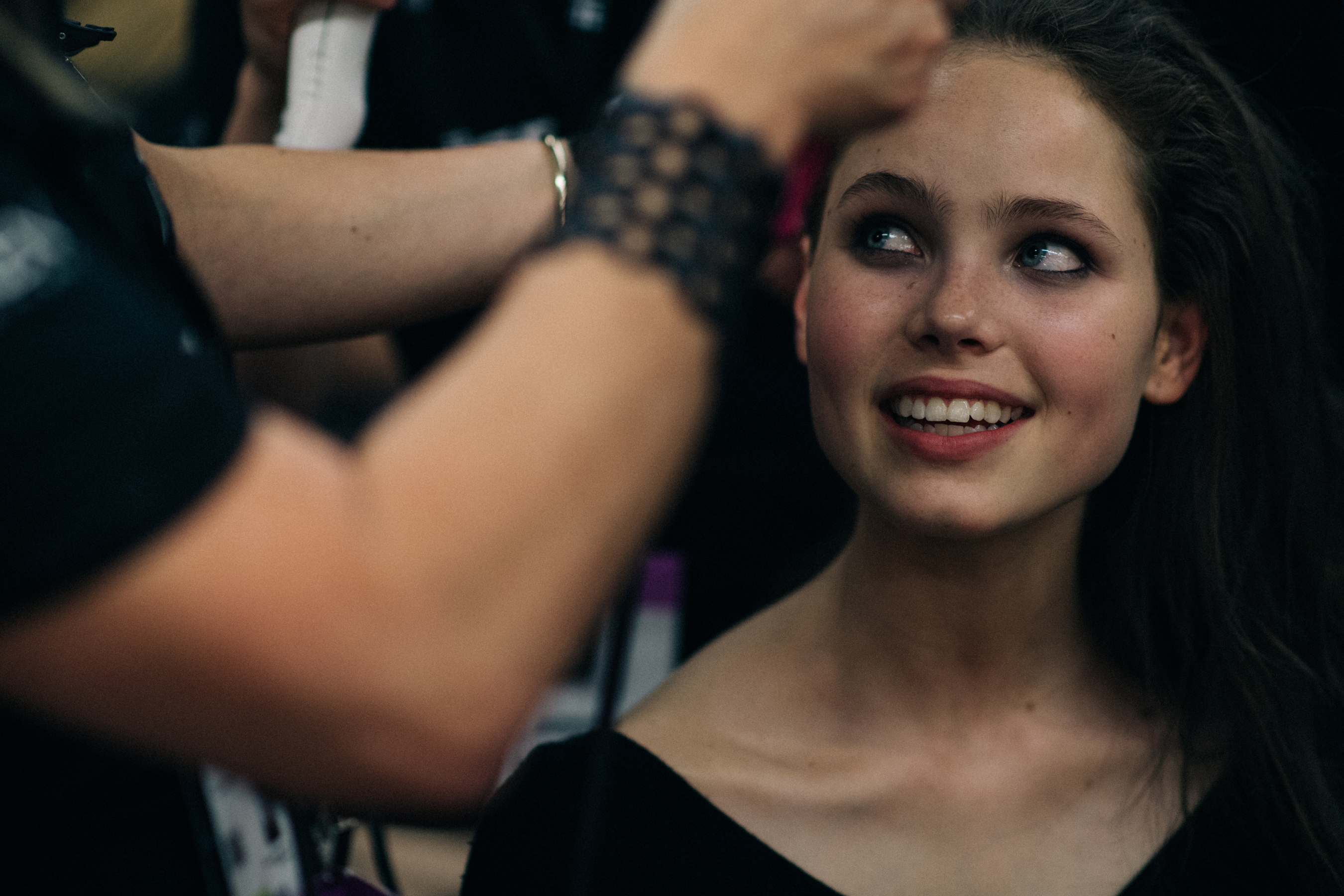 Model laughing while hair done