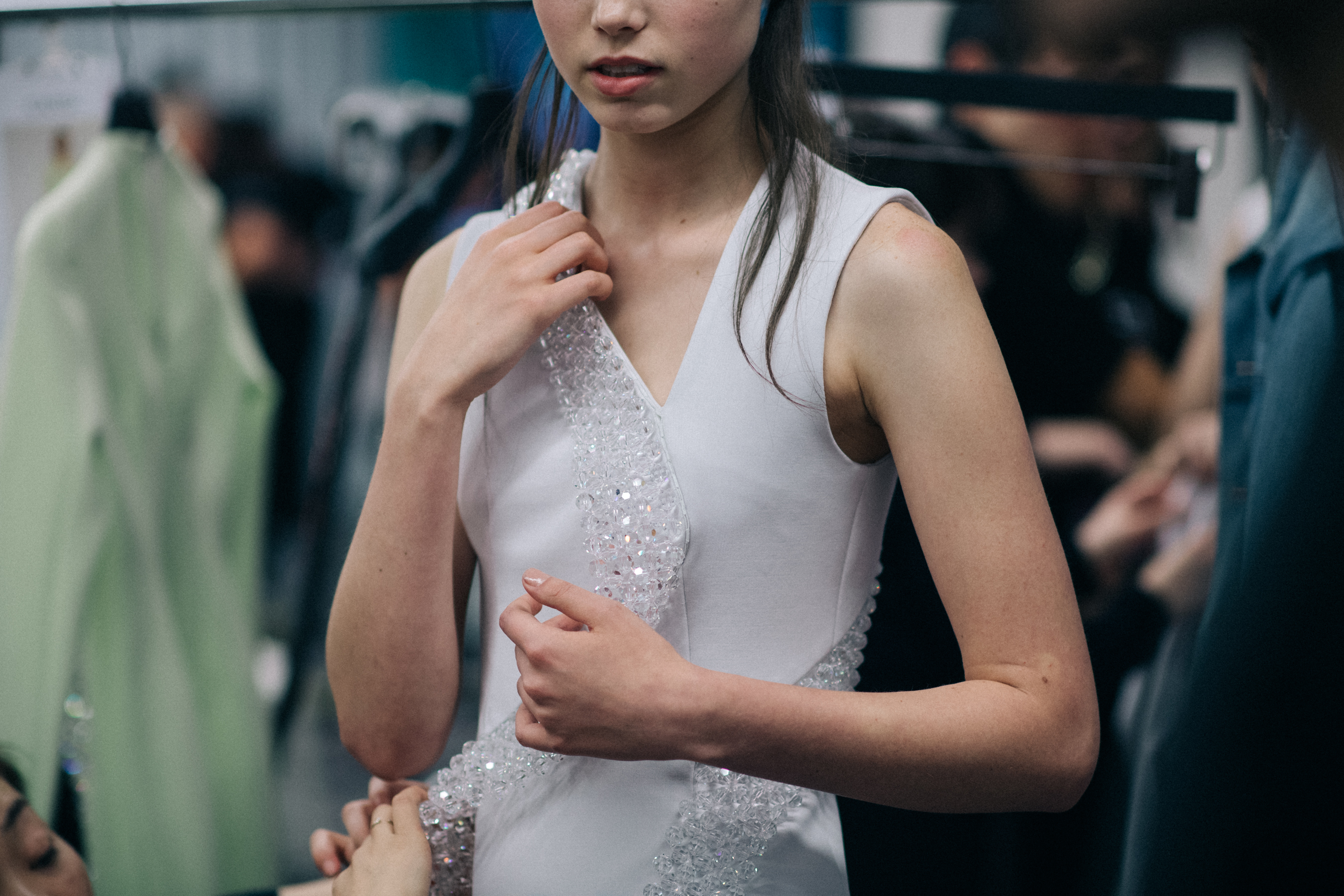 Model wearing white crystal dress