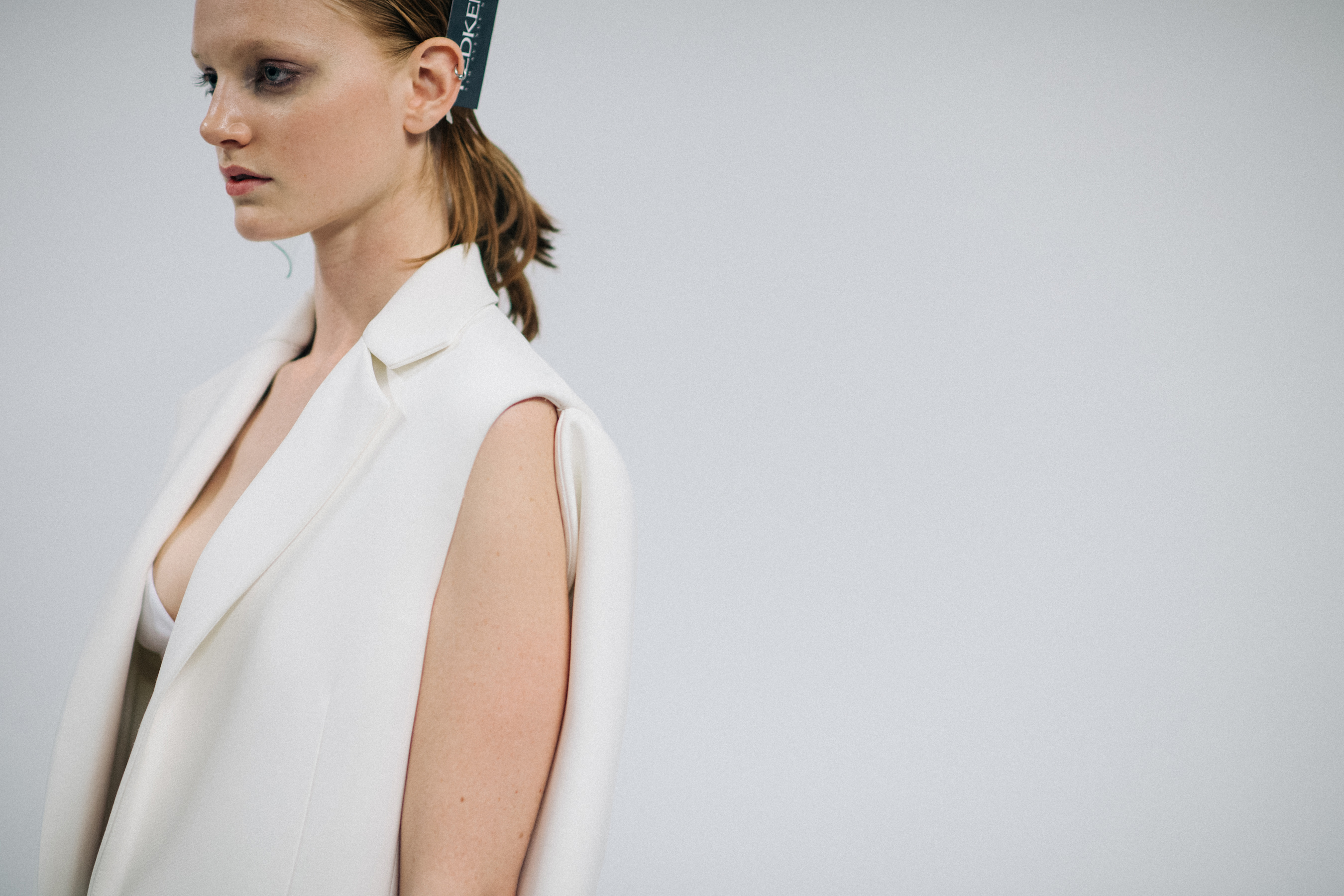 Model wearing all white vest