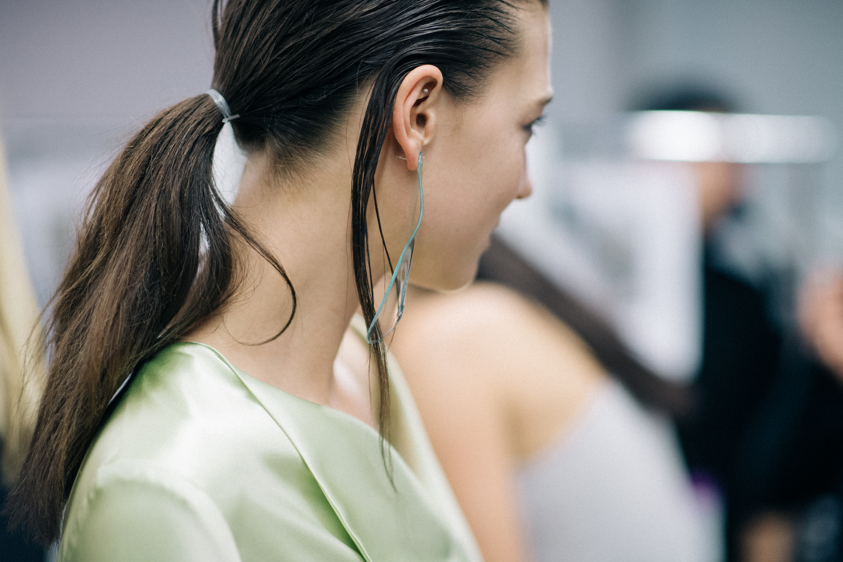 Model wearing transparent glass earring