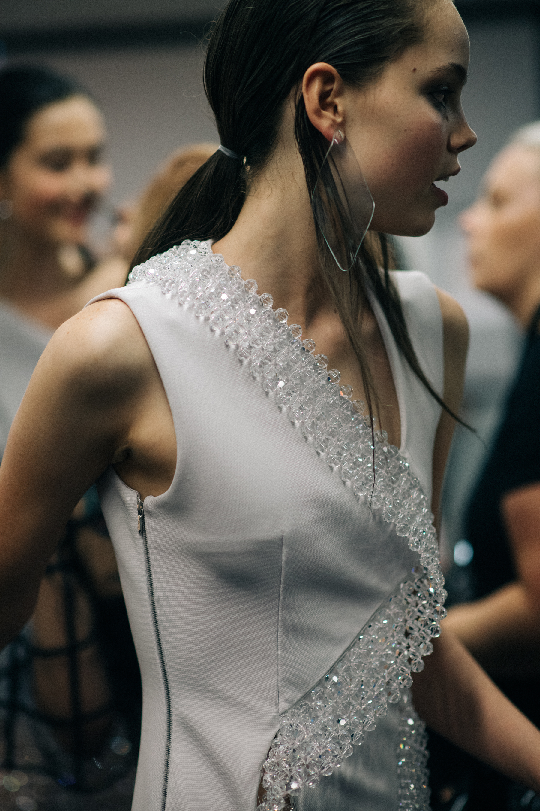 Model wearing white dress with crystals