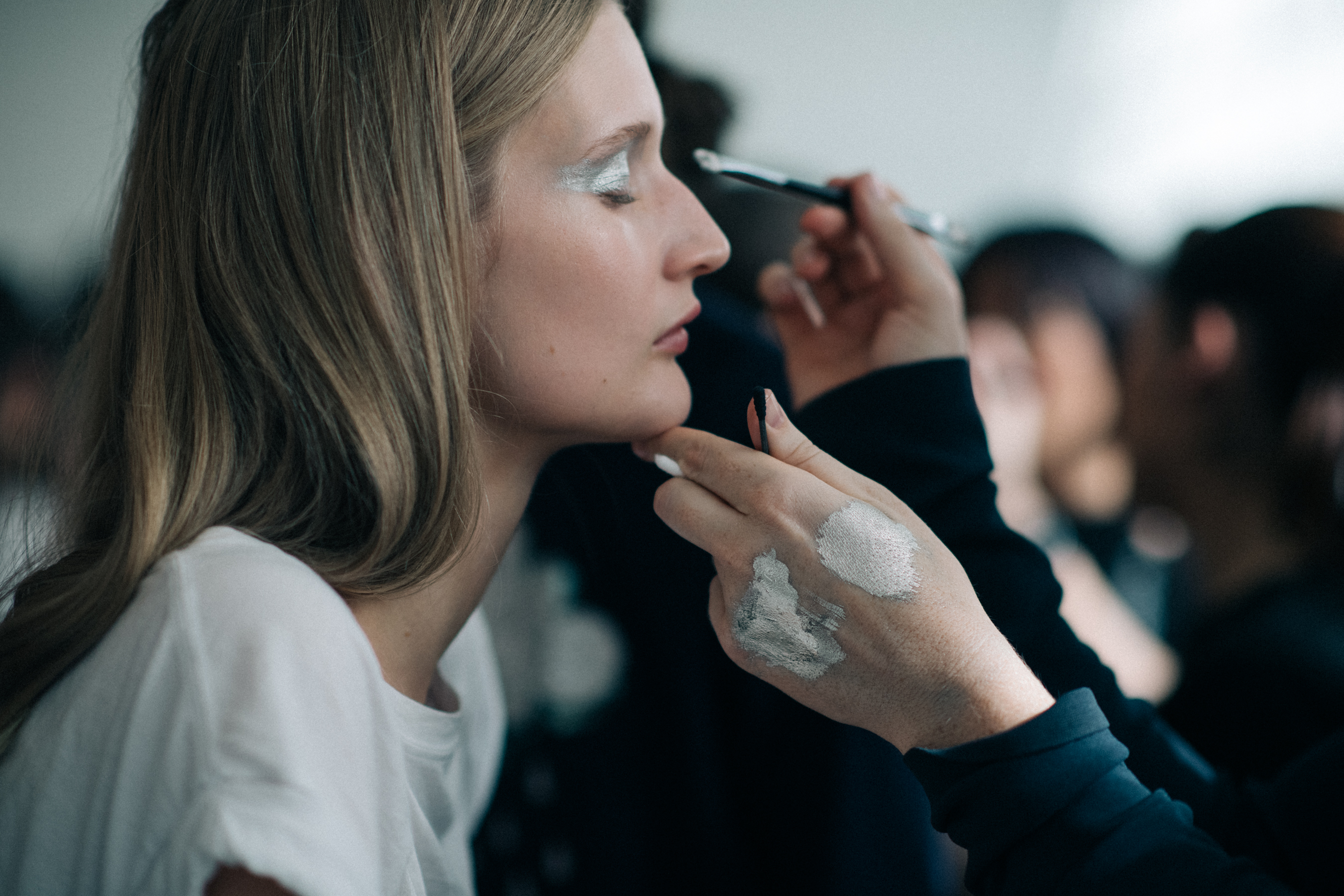 A model backstage getting her make-up done