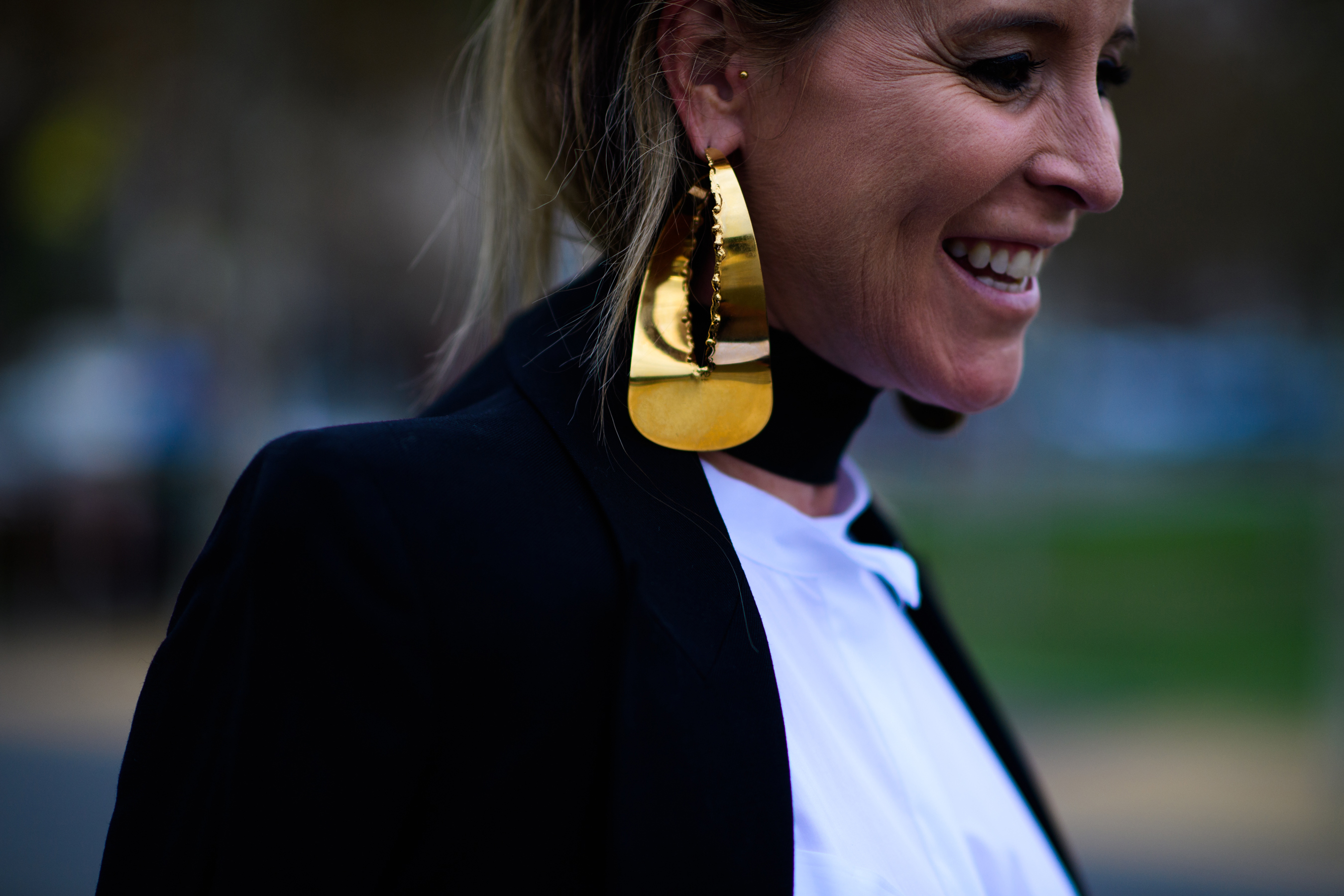 Woman wearing big gold earring