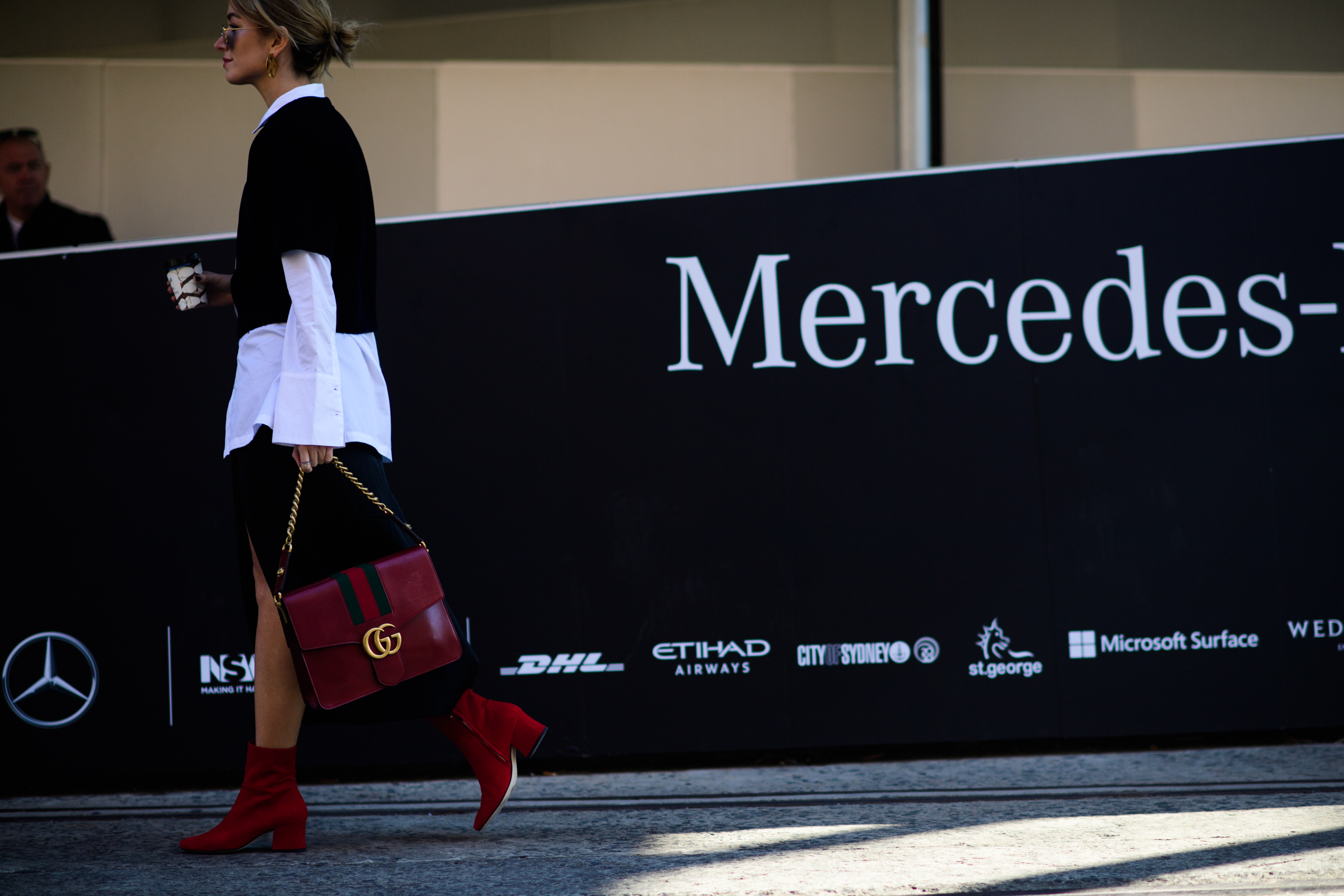 Blogger wearing red boots and gucci bag