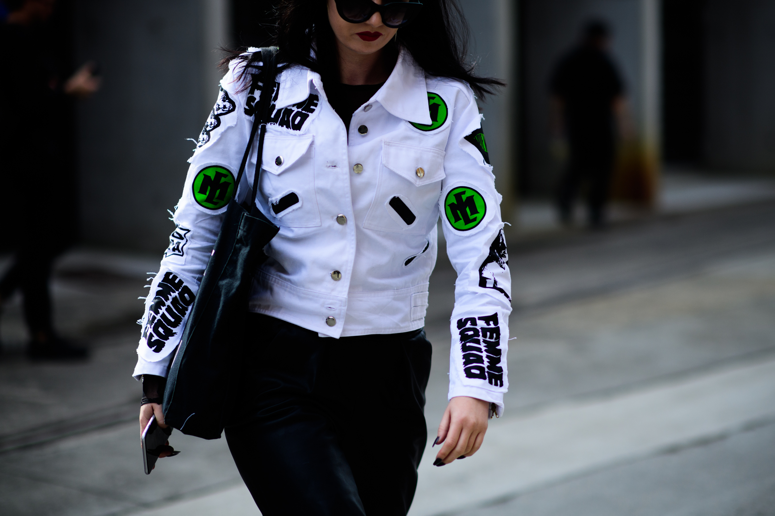 Girl wearing white jacket with patches