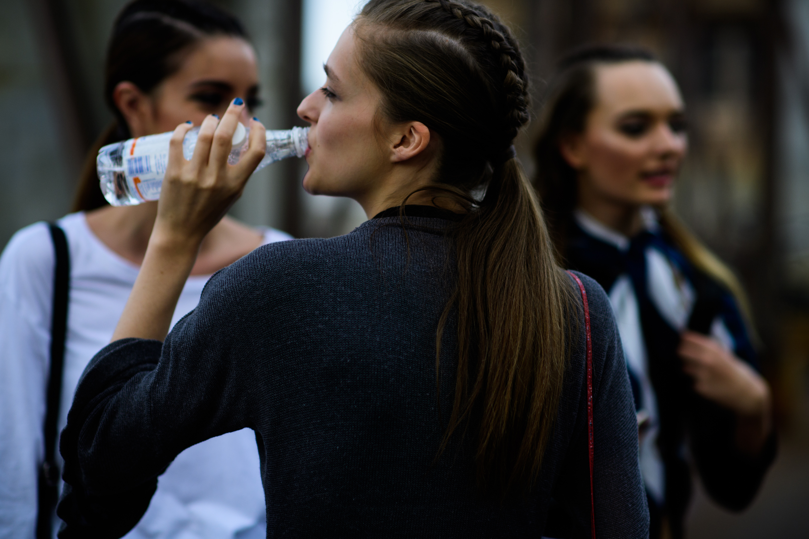 Model with braided hair drinking water