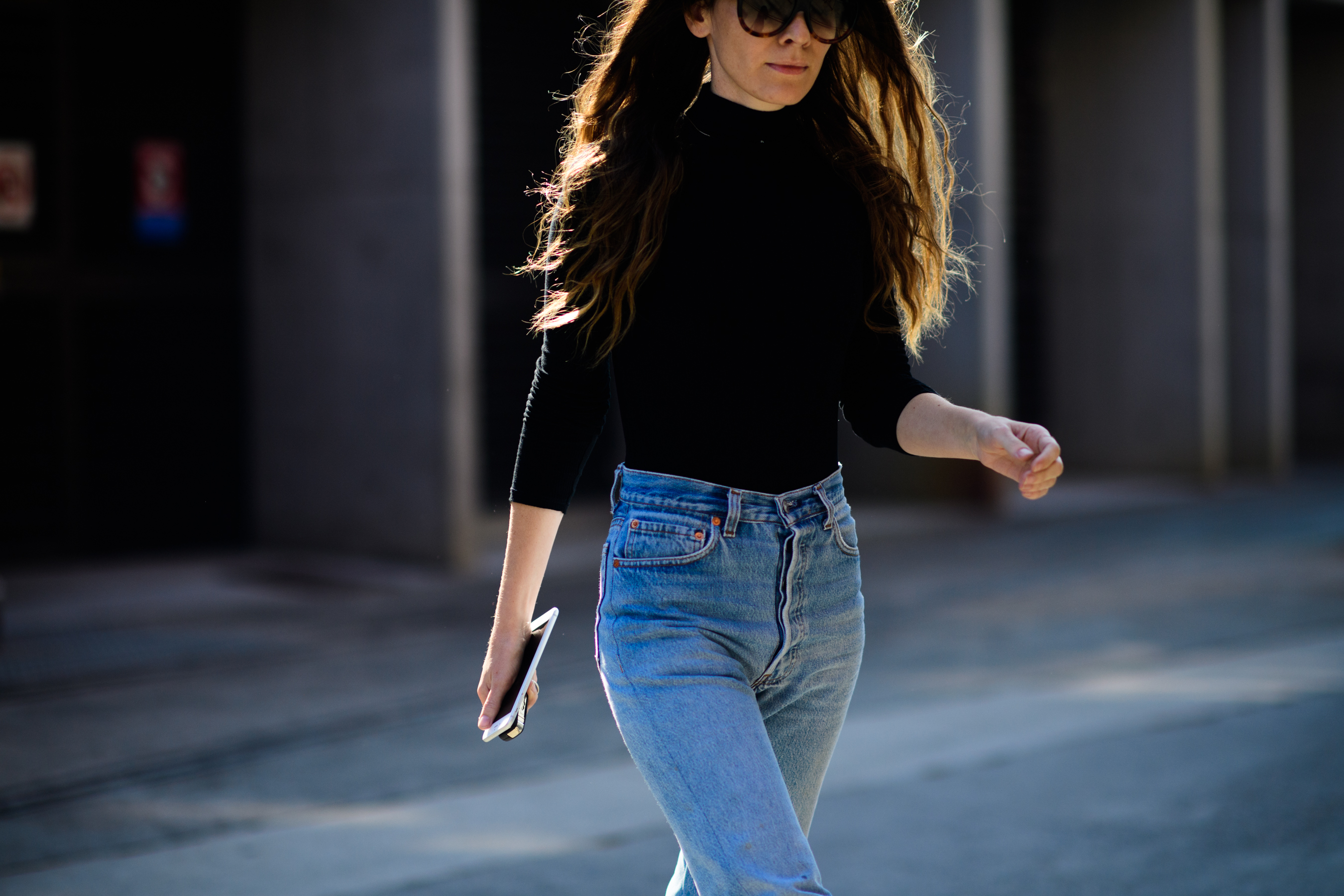 Woman wearing jeans and black top
