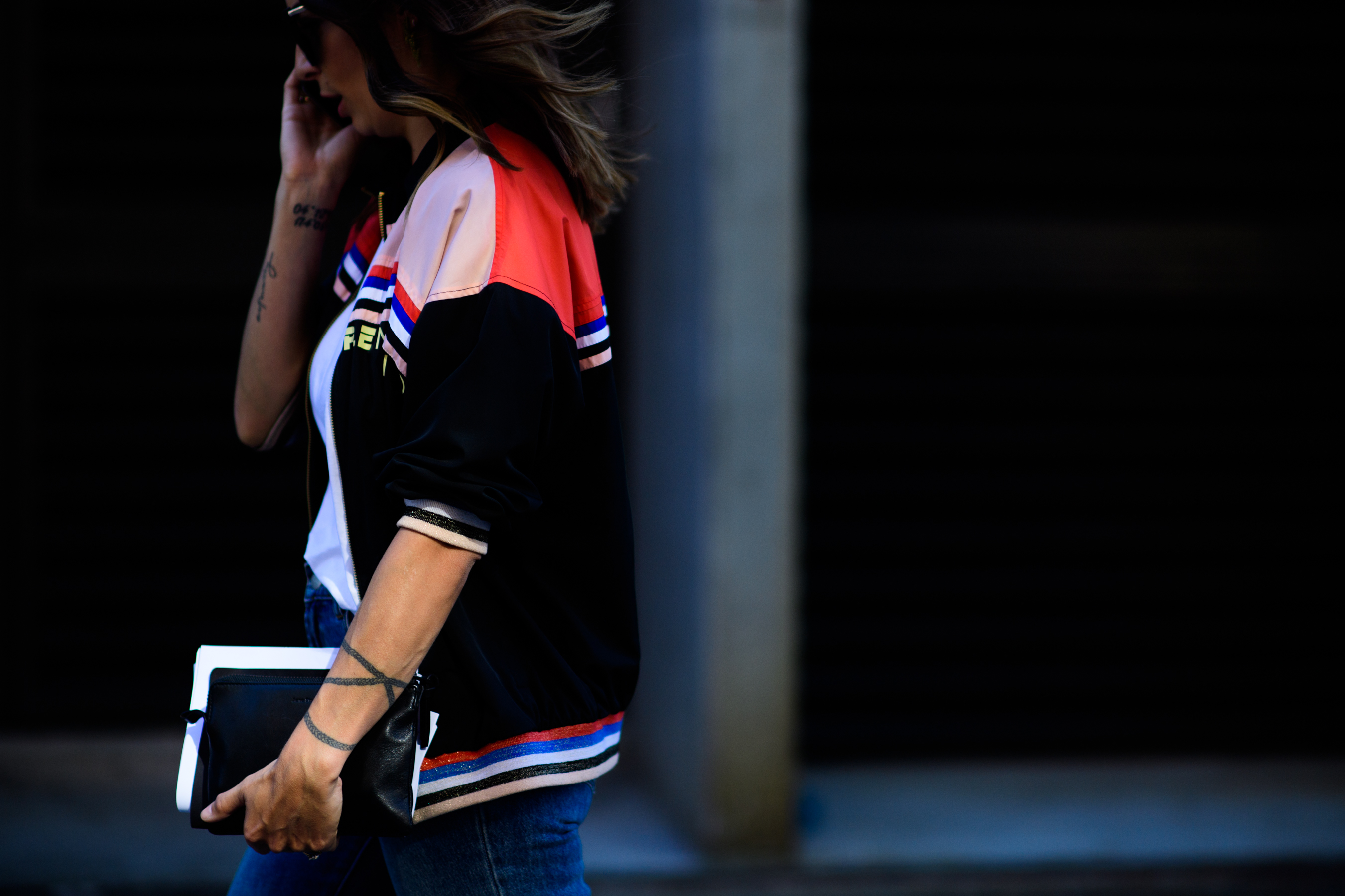 Woman wearing colourful bomber jacket