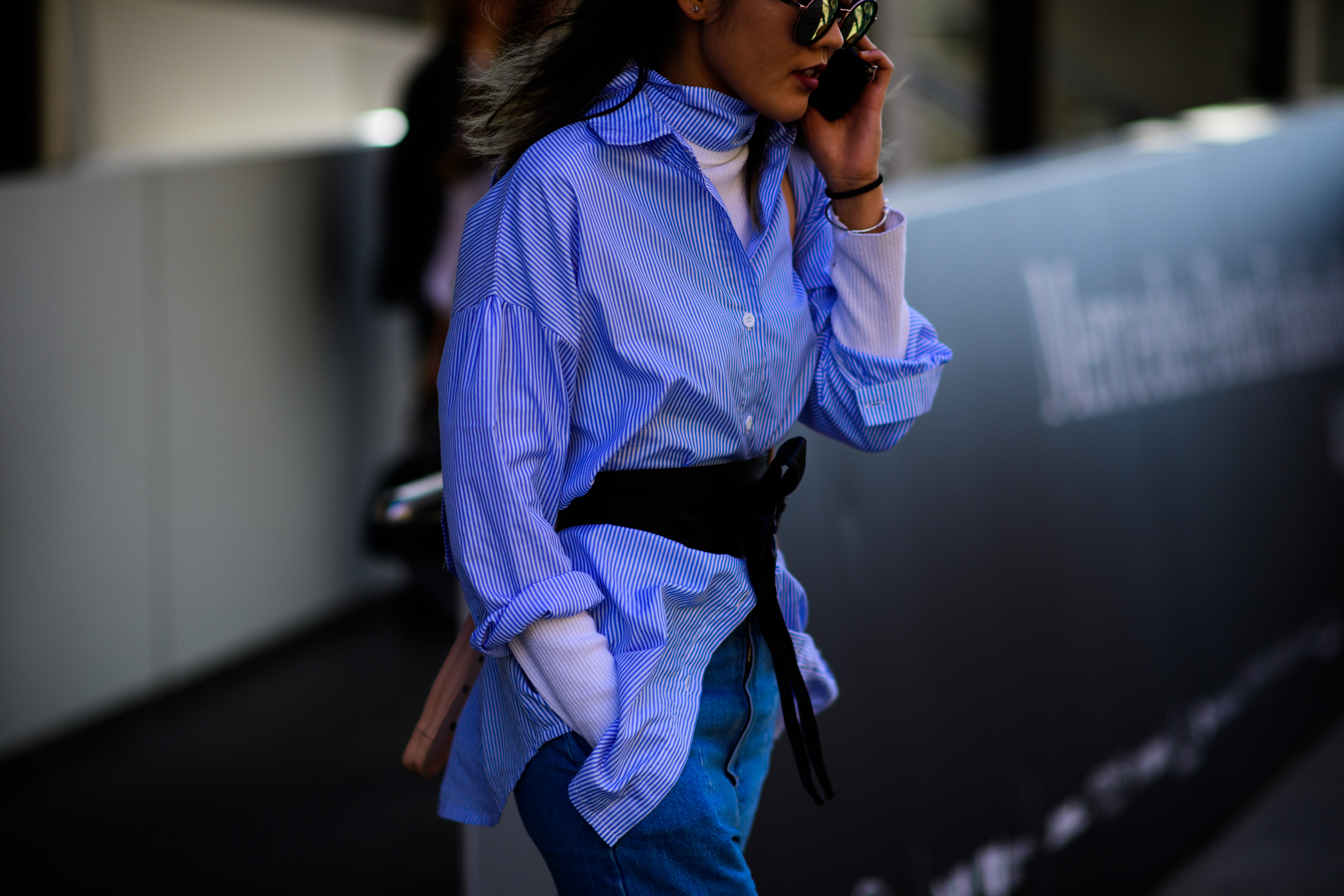 Woman wearing blue shirt over sweater