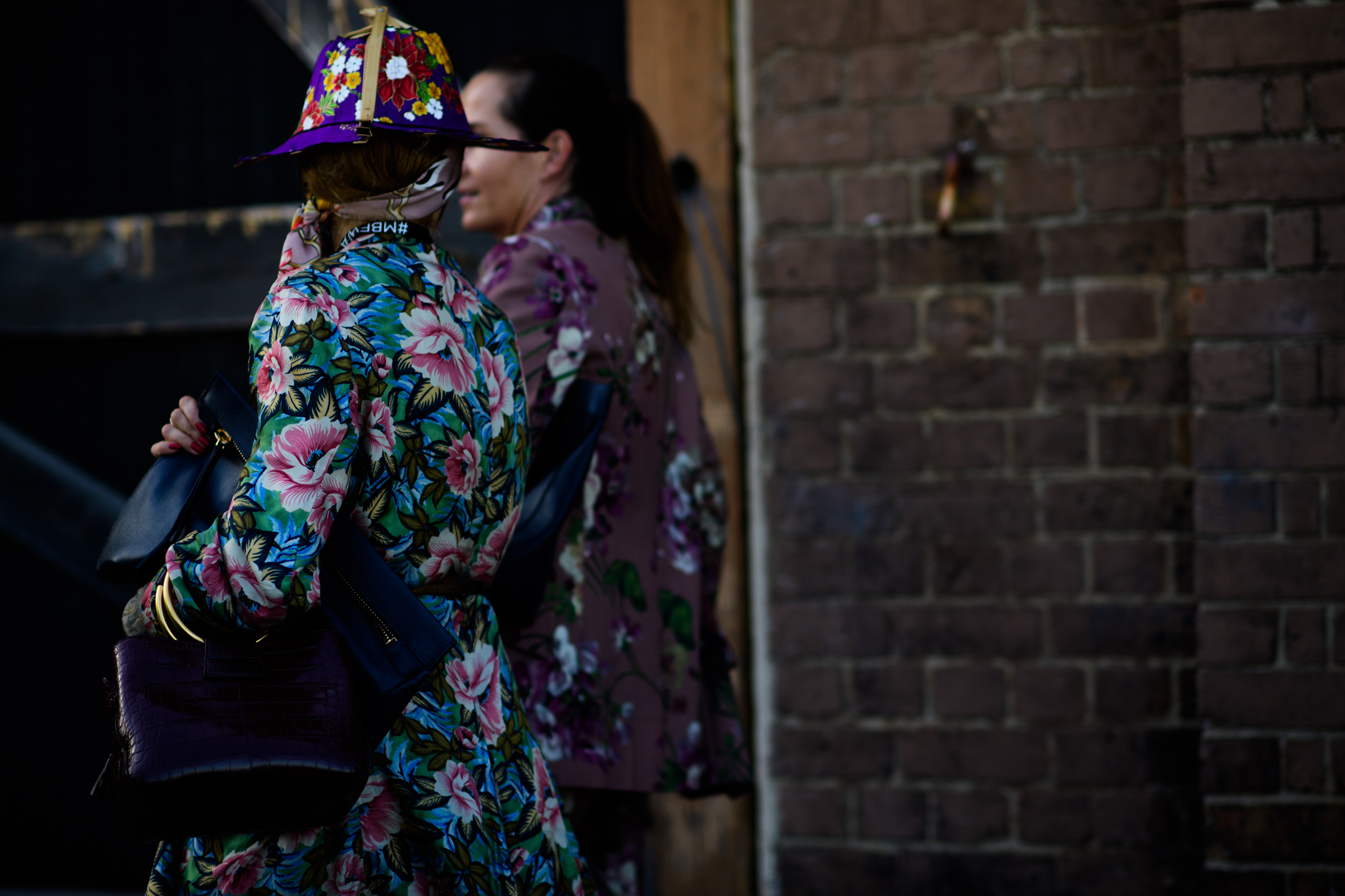Two women dressed in floral outfits