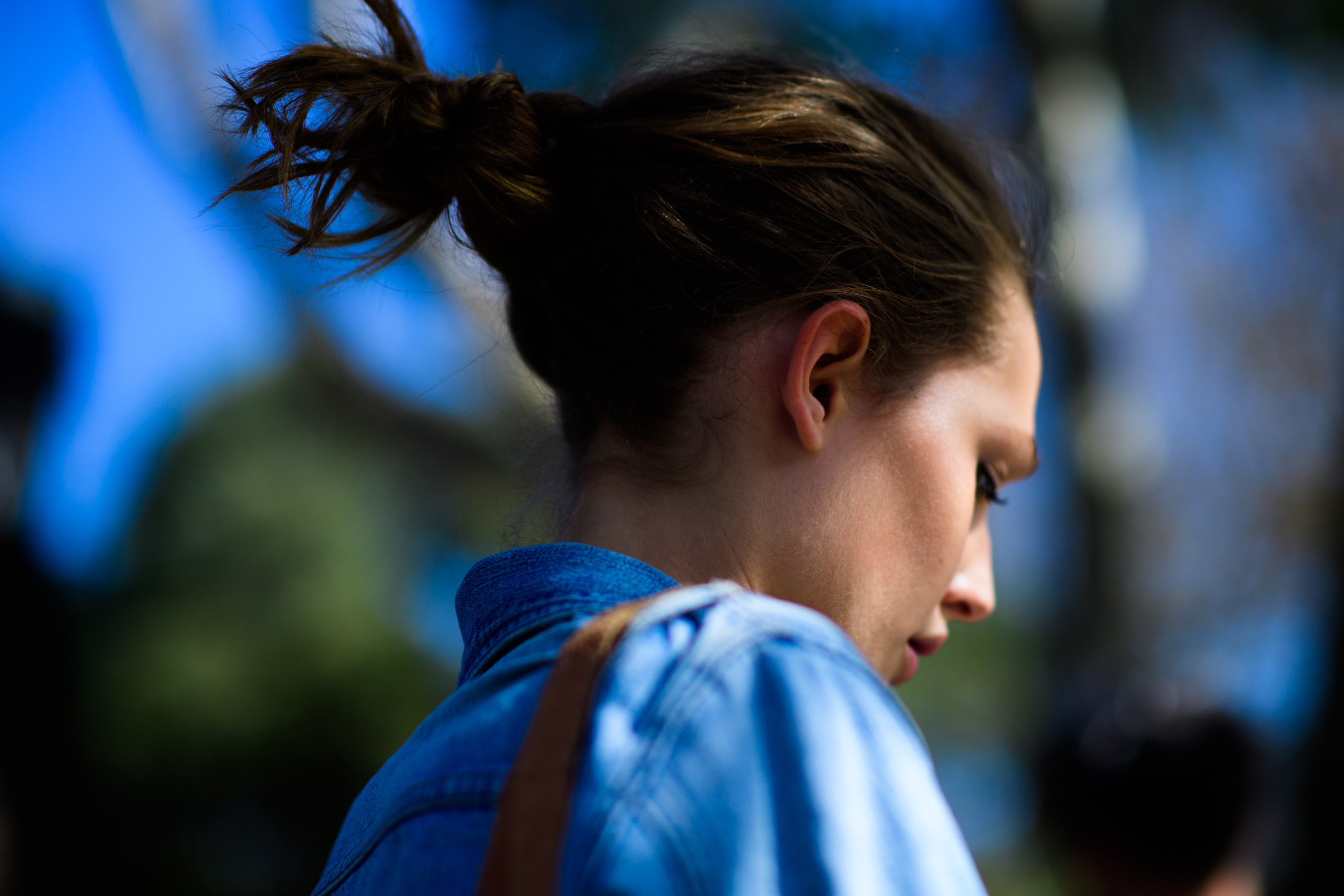 Model with hair tied denim shirt
