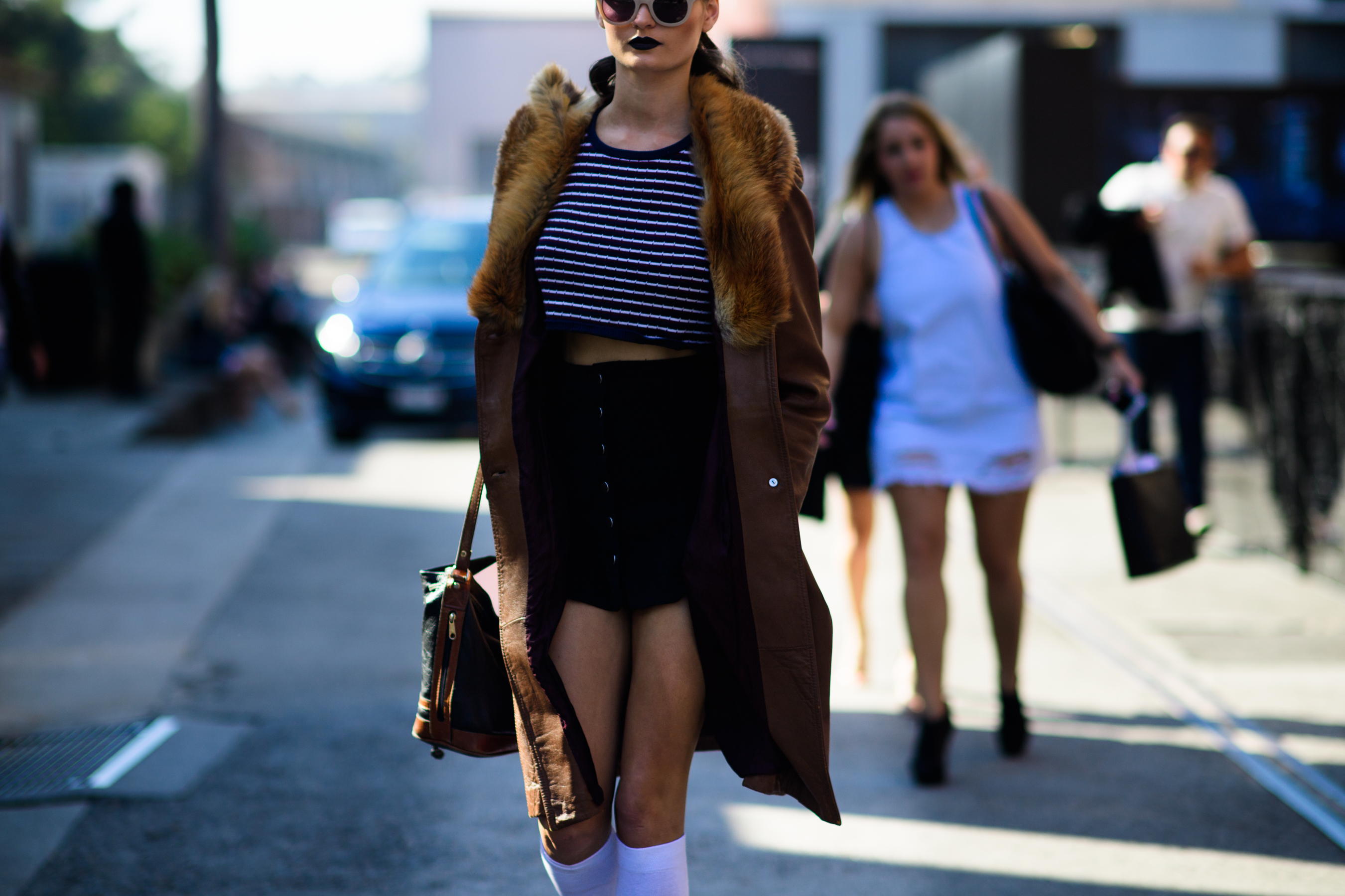 Model wearing coat with fur collar