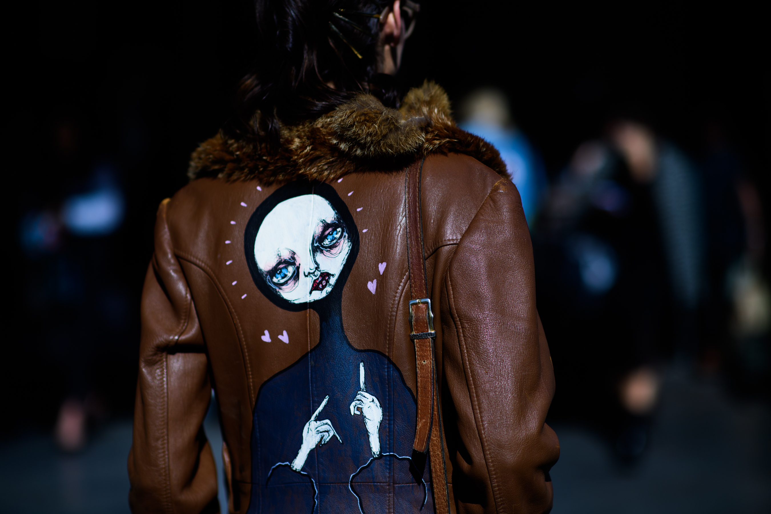 Girl wearing jacket with painted back