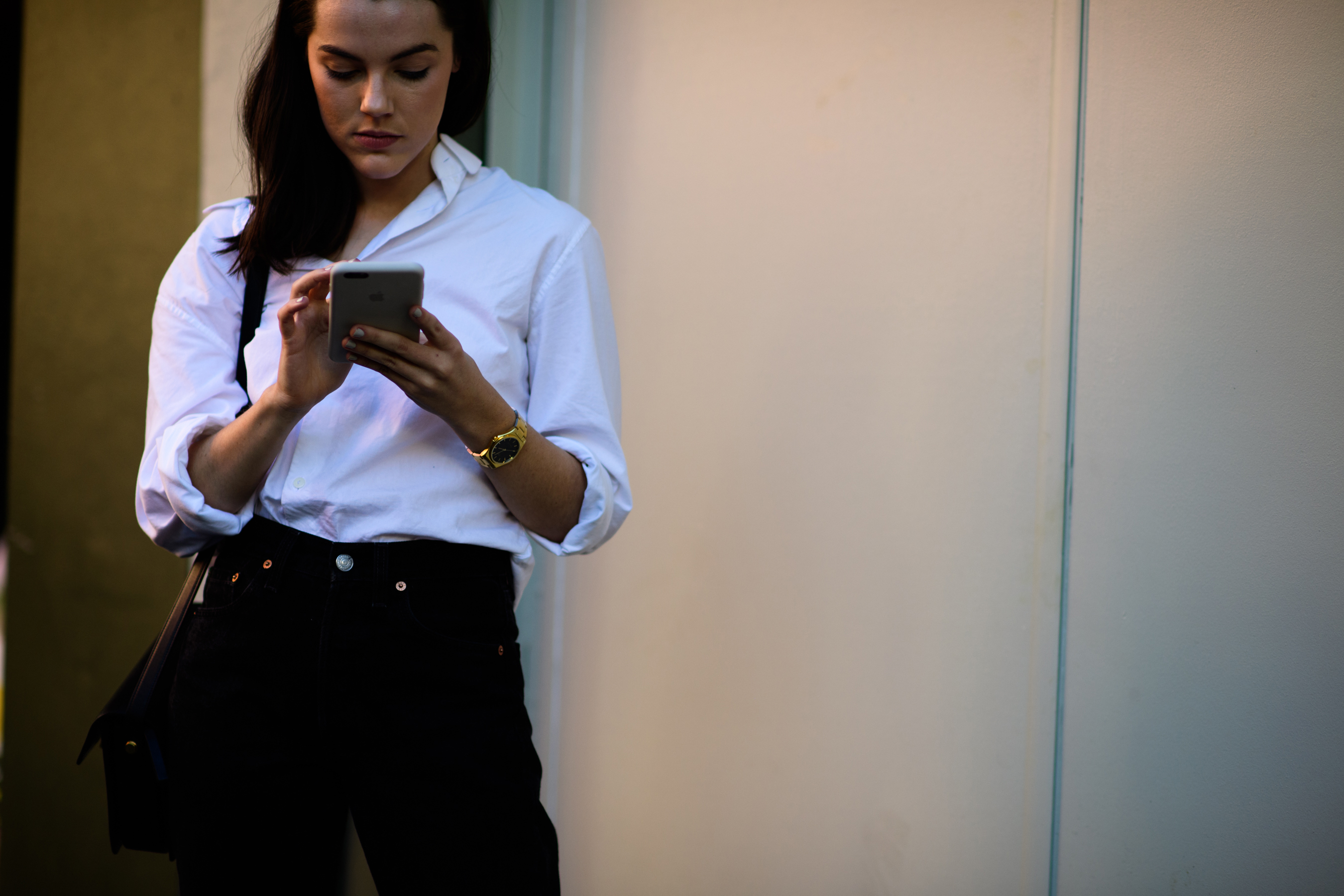 Woman wearing white shirt gold watch
