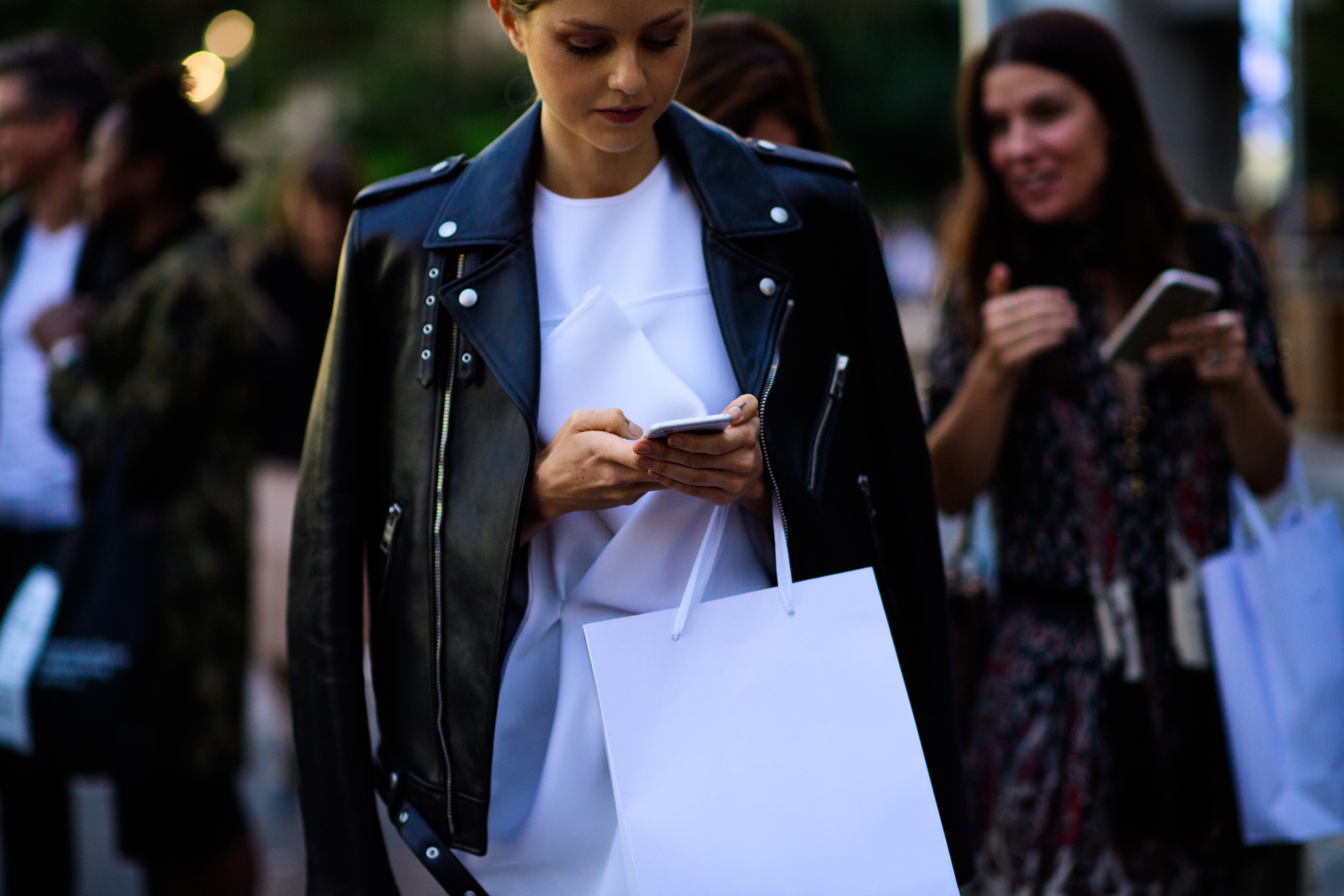 Woman wearing leather jacket white top