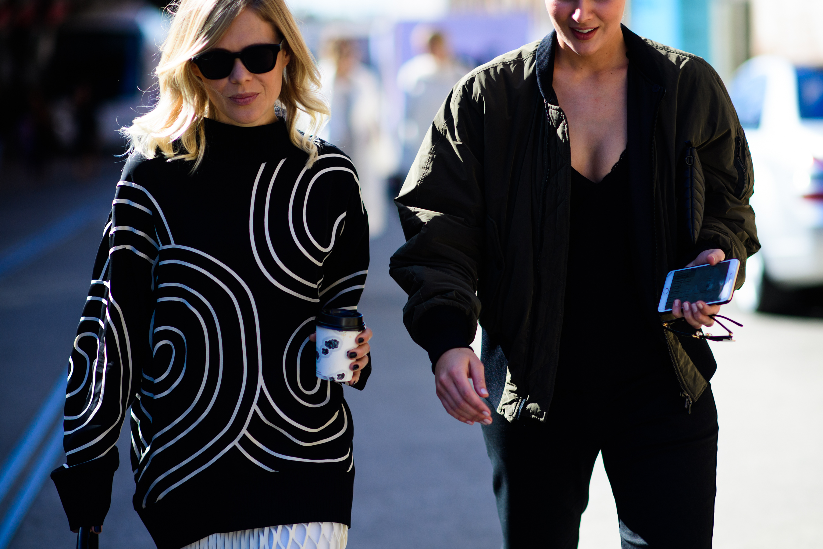 Two women wearing bomber and sweater