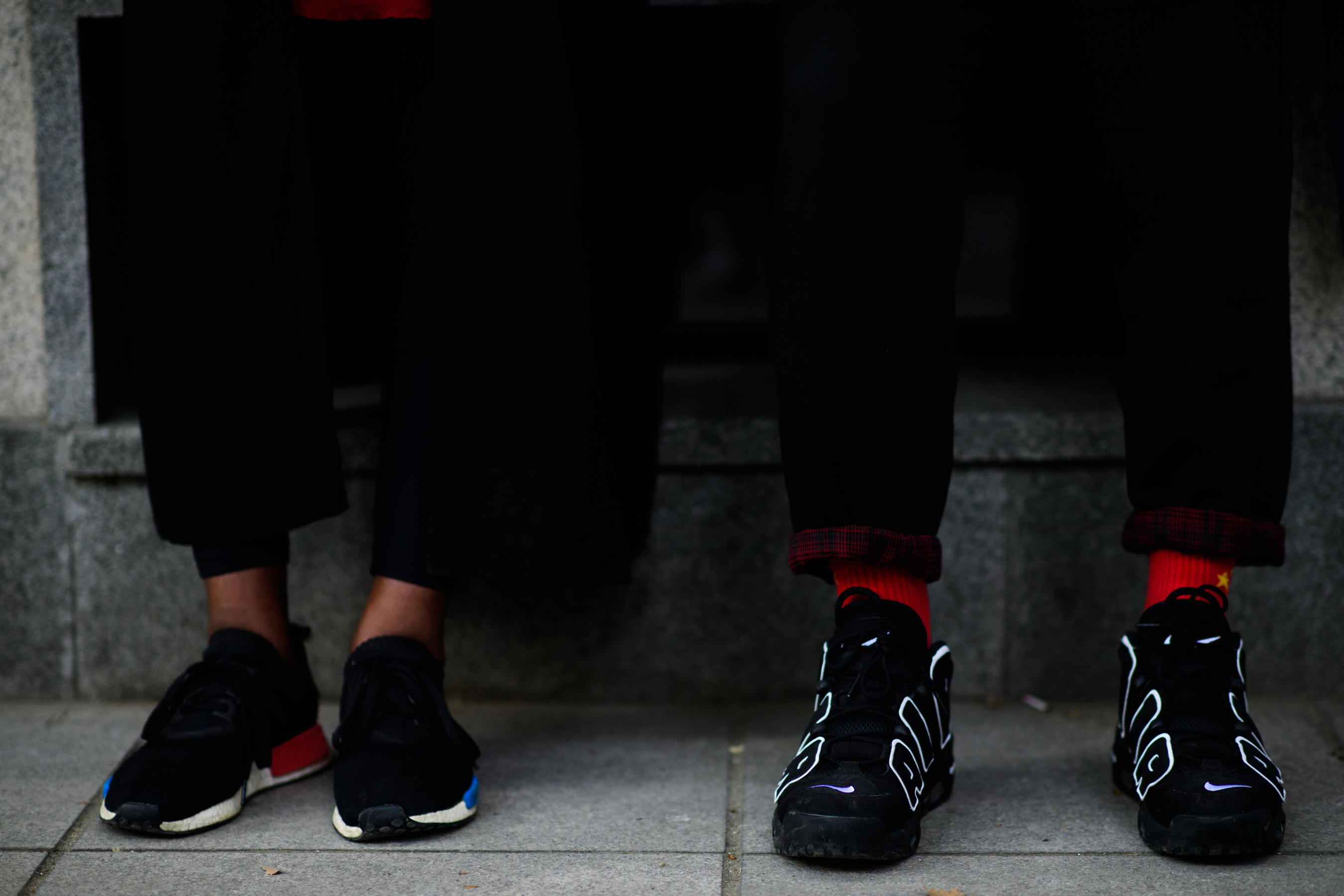 Two men wearing Nike and Adidas