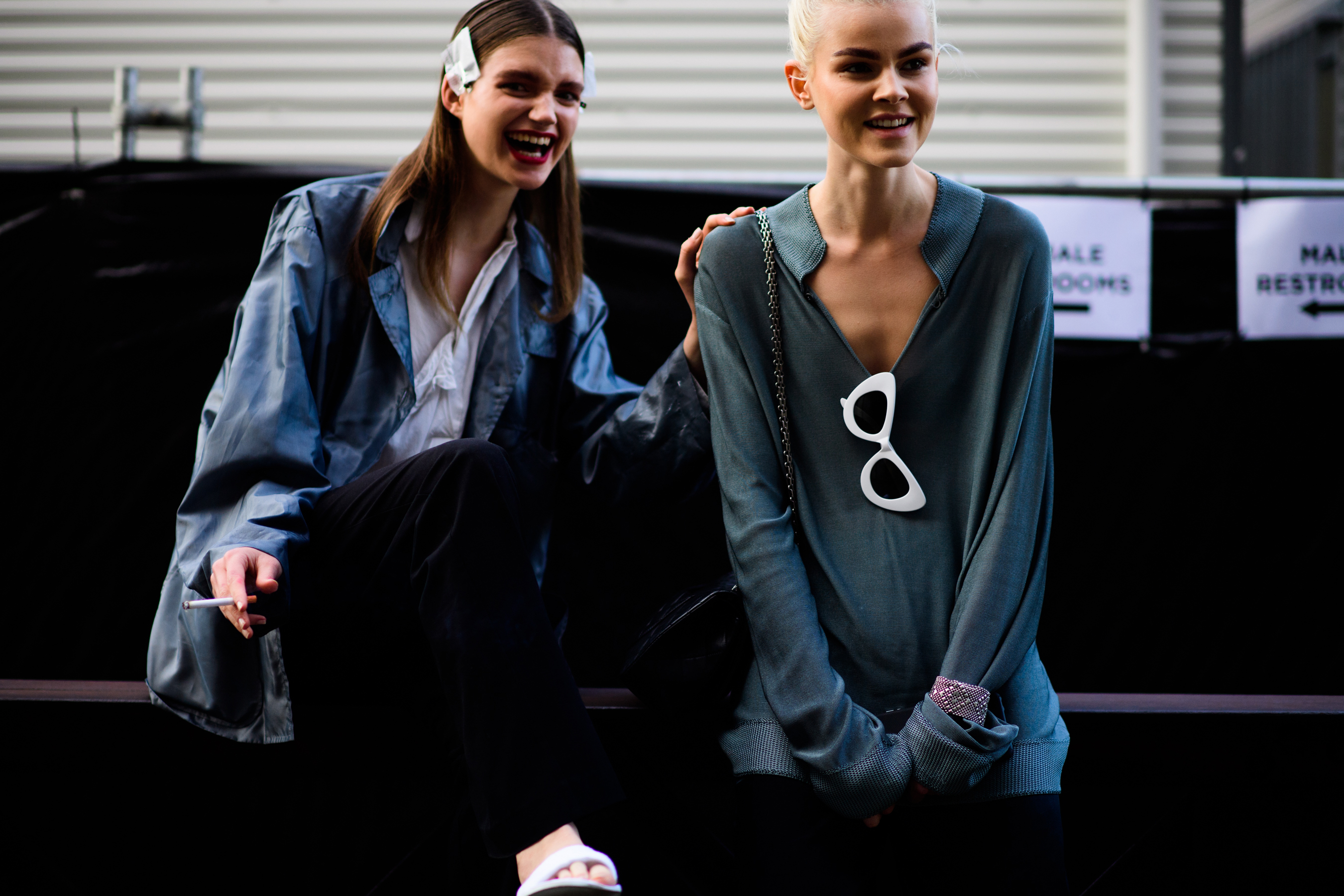 Two models wearing blue shirts
