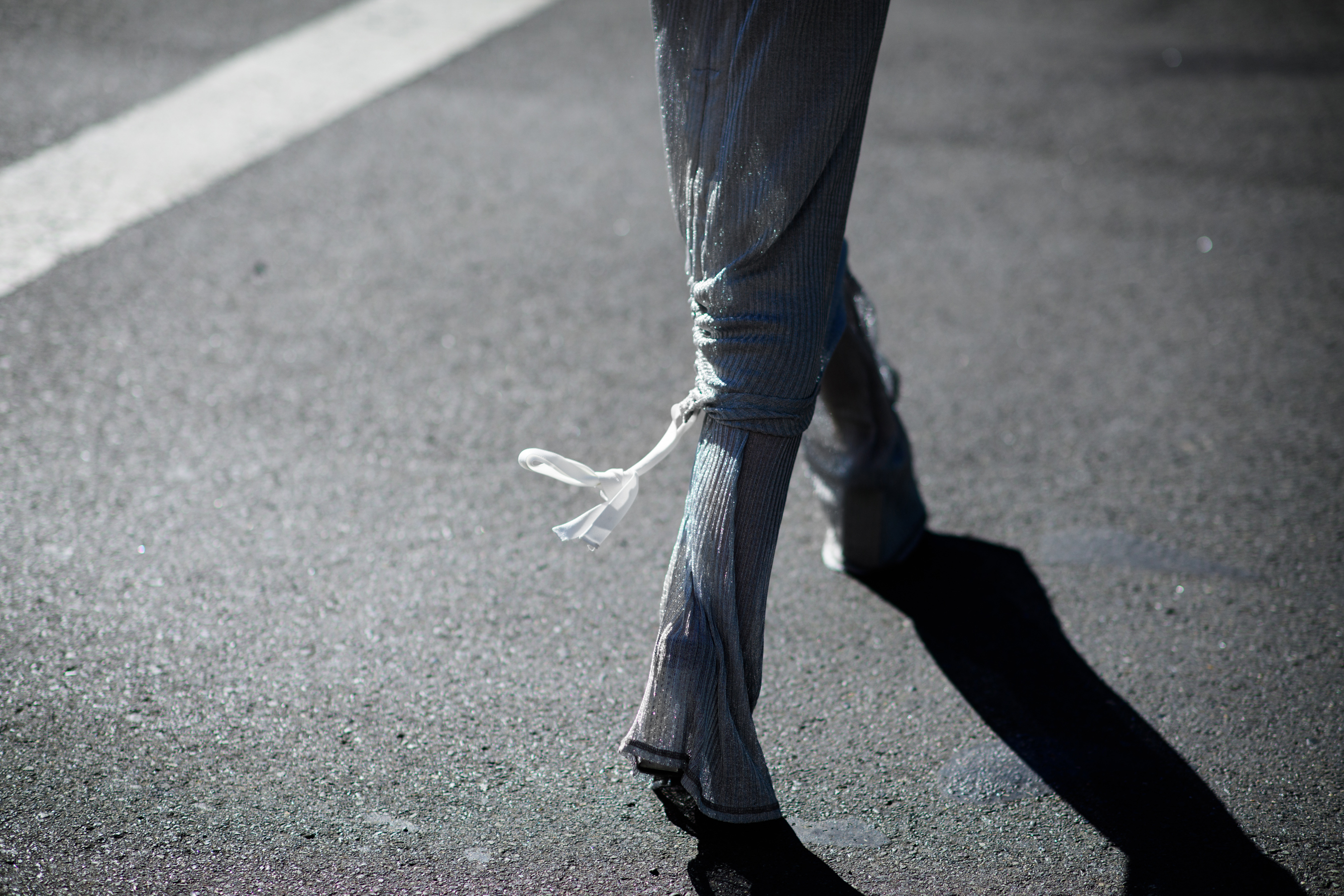 Woman wearing long silver pants