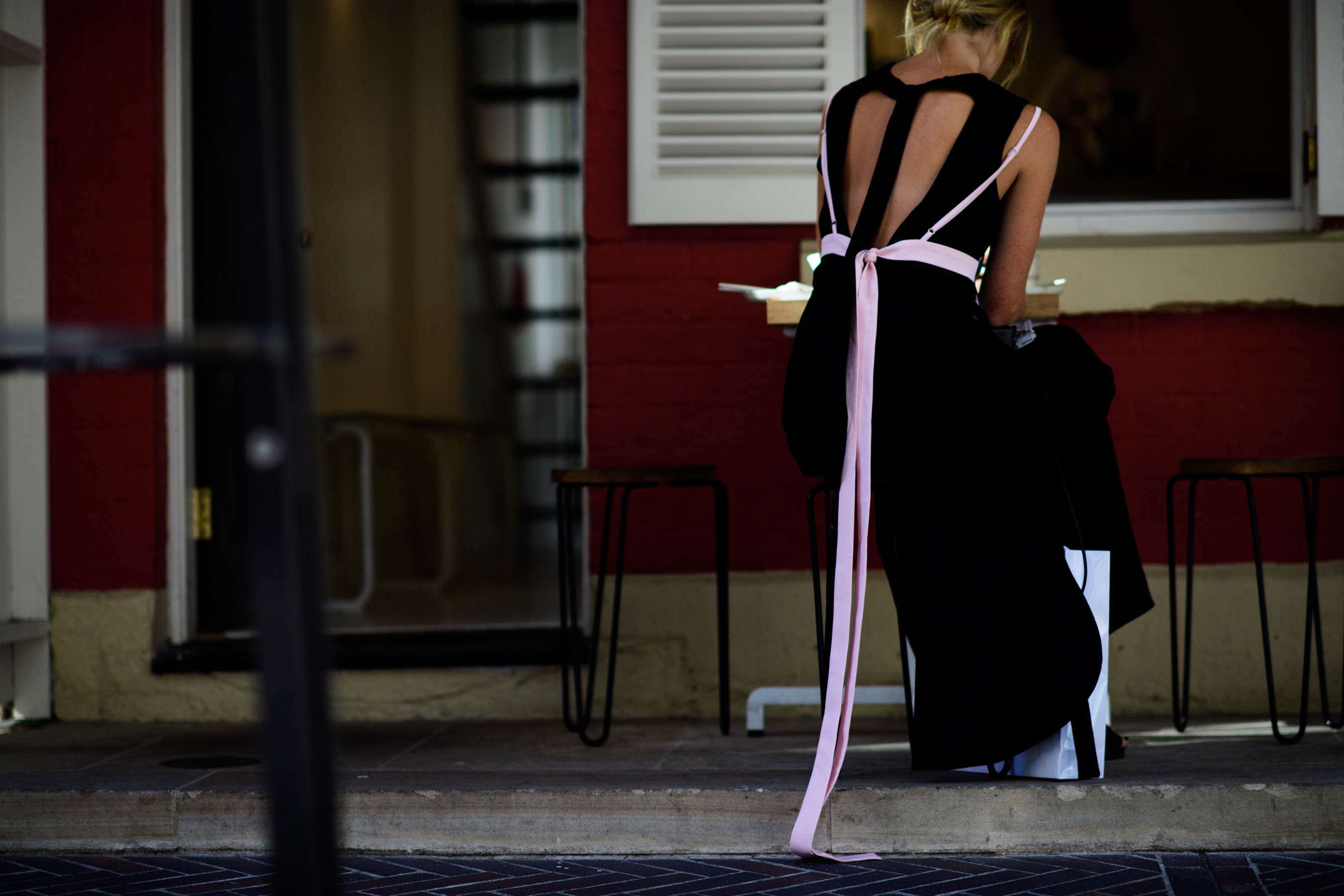 Woman wearing black dress with ribbon