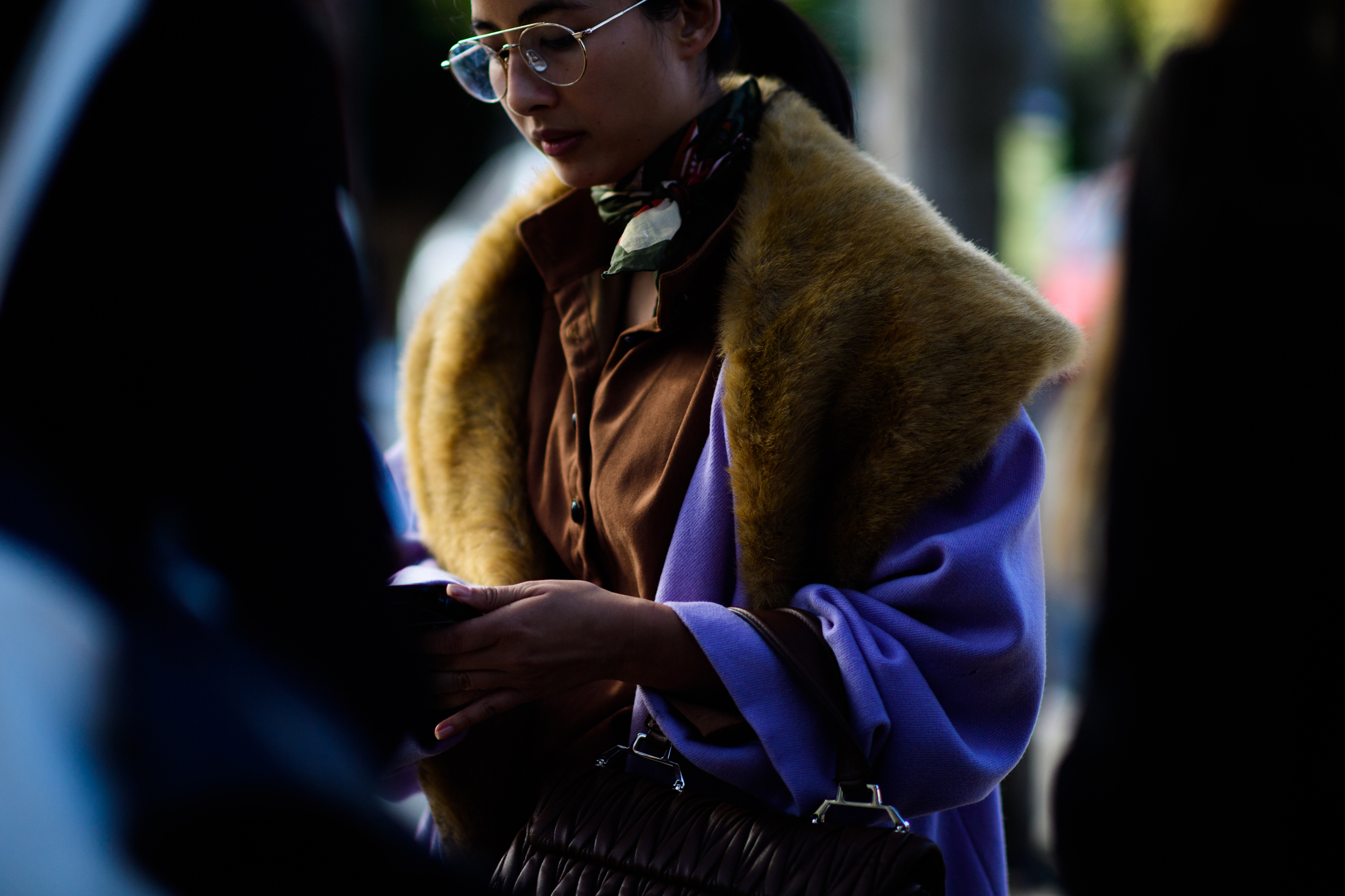 Woman wearing purple coat with yellow