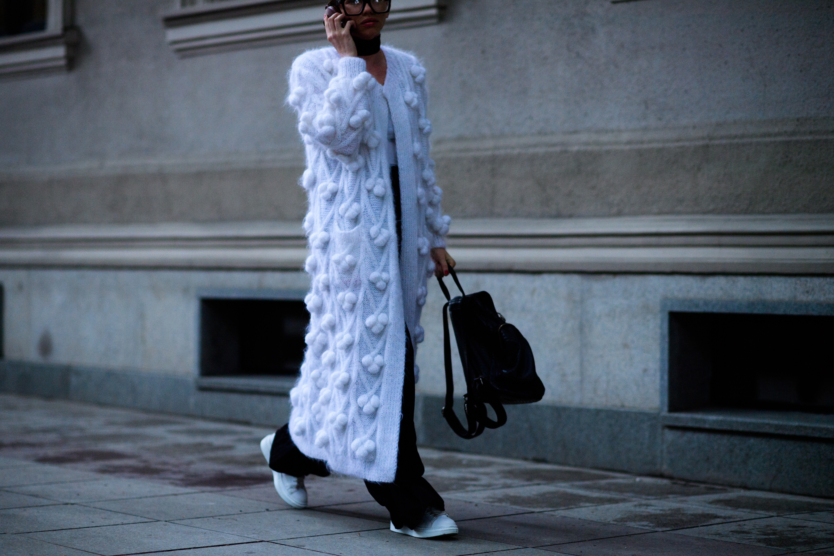 Woman wearing long white cardigan