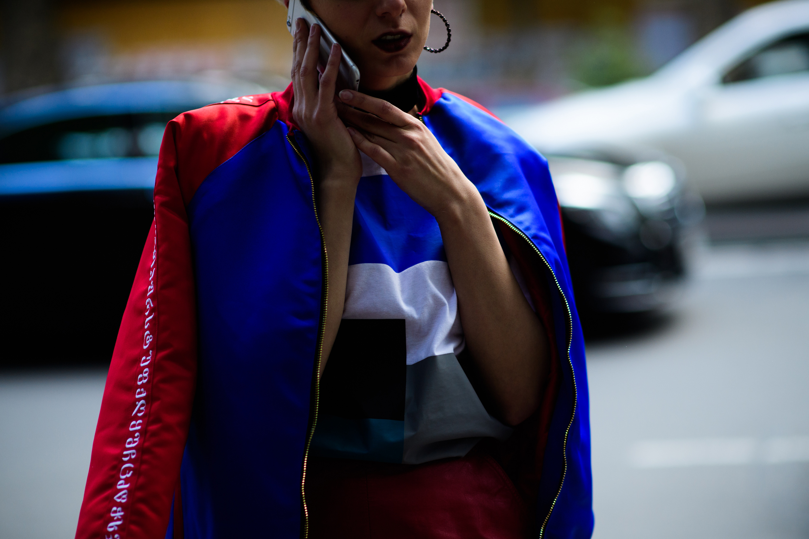 Woman wearing blue and red bomber