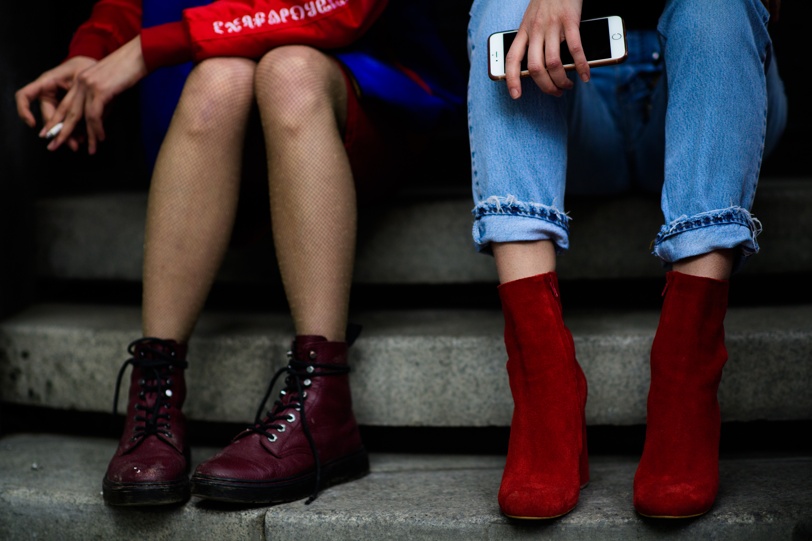 Two women wearing red boots