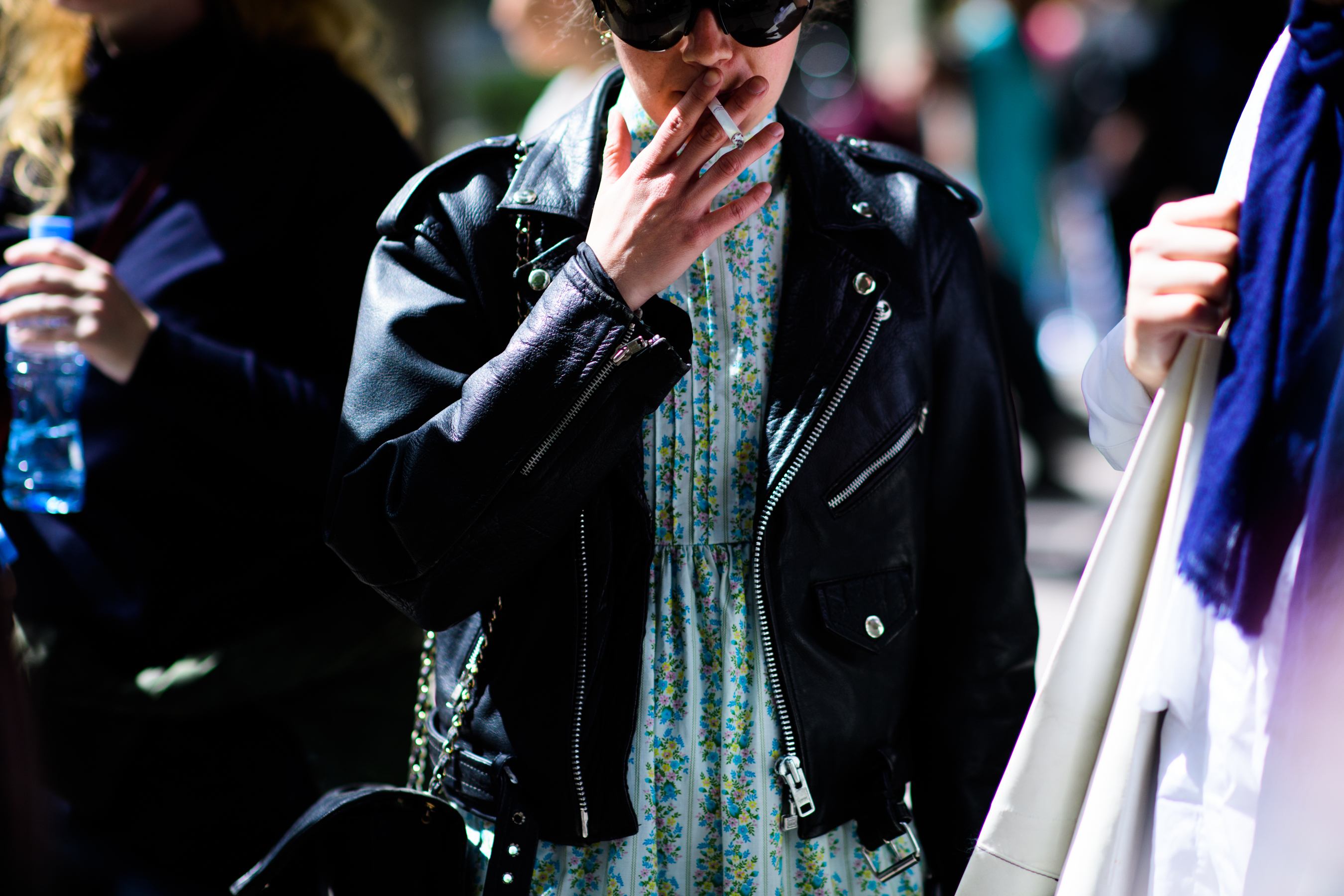 Woman in floral dress leather jacket