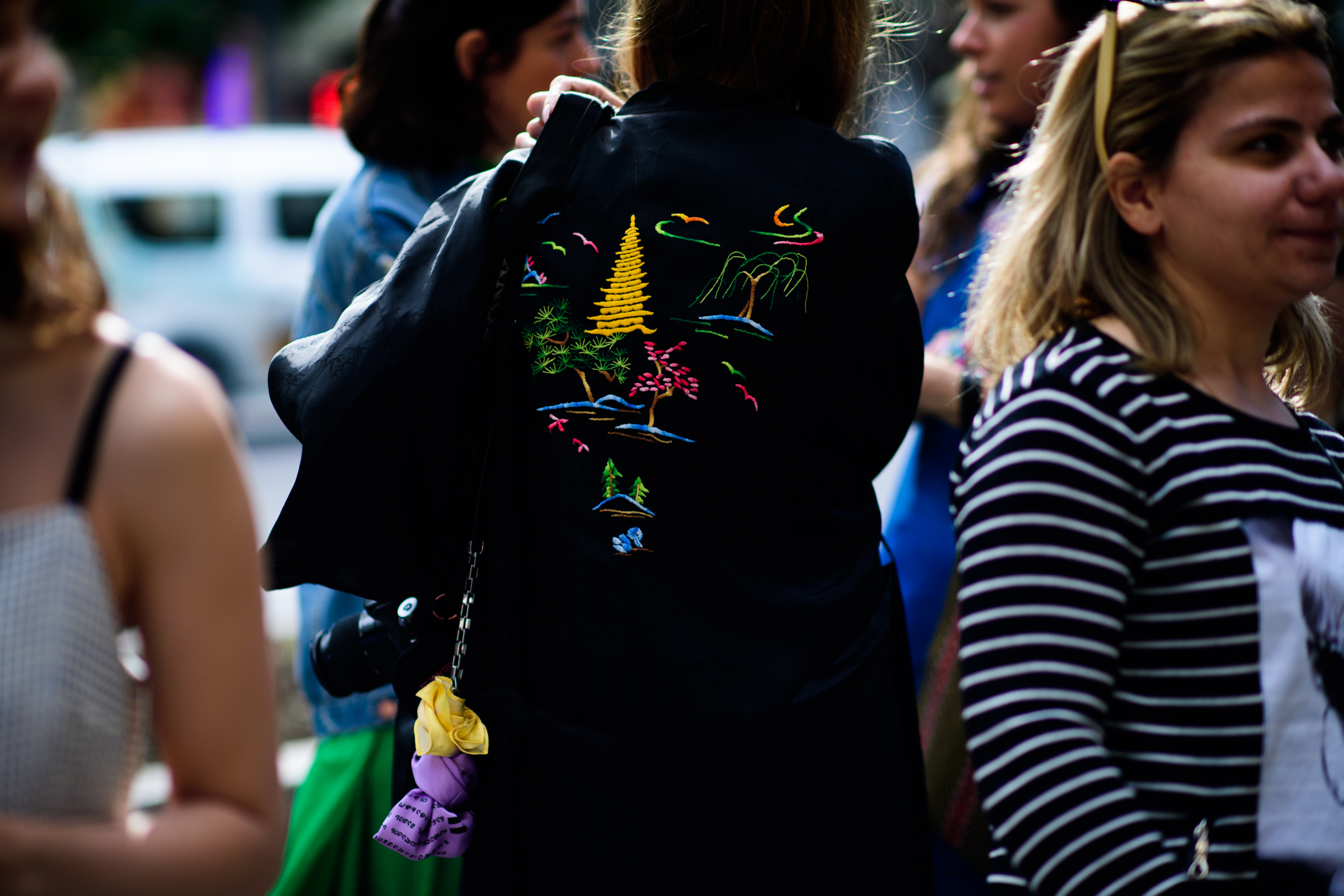 Woman wearing embroidered black bomber