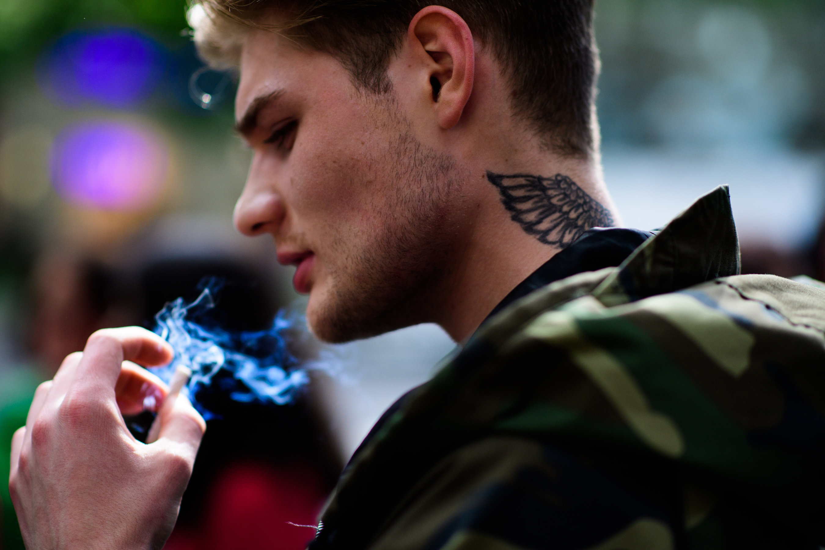 Man with a wings tattoo on neck