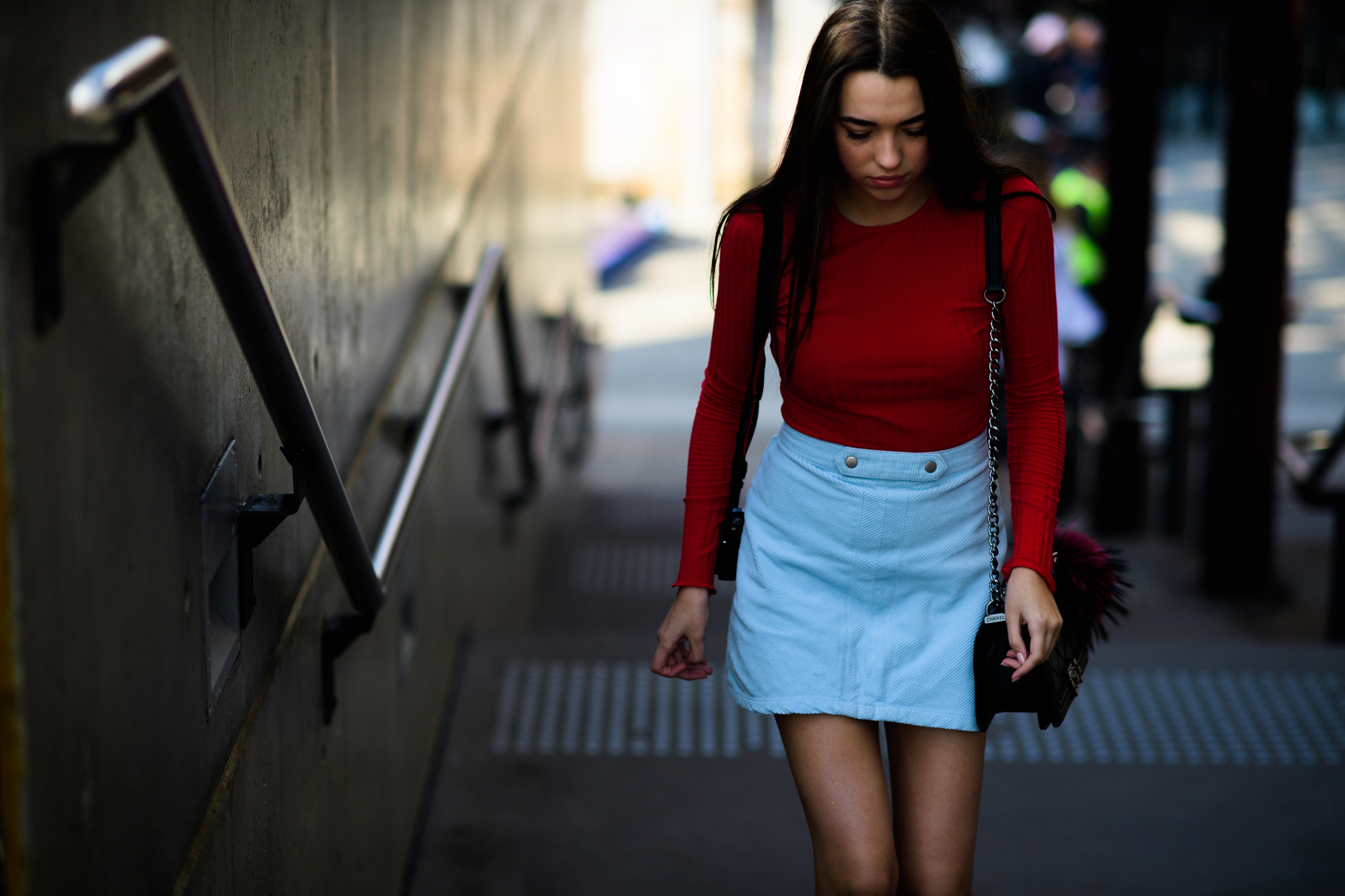 Model wearing red sweater and denim