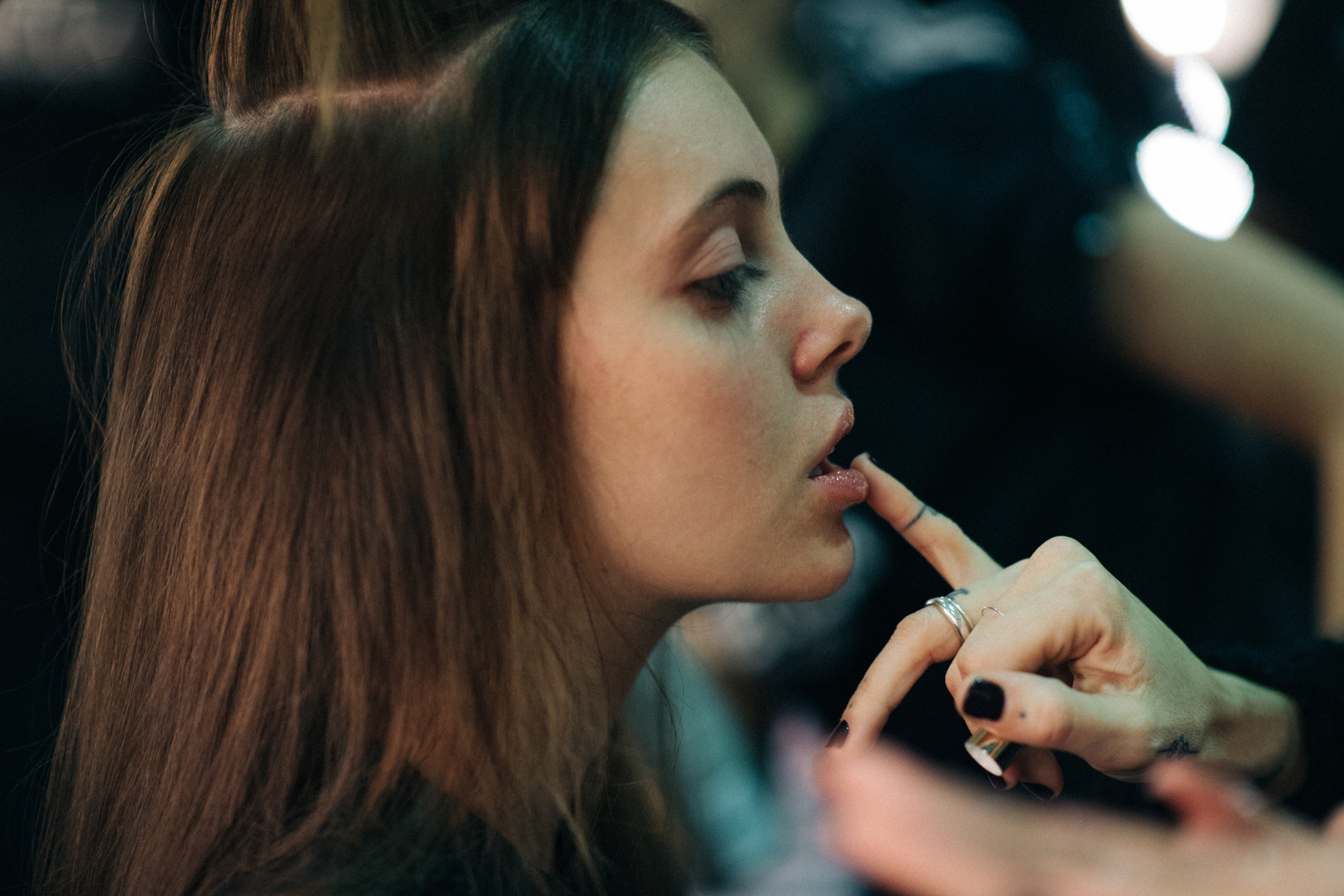 Model getting her make-up done backstage