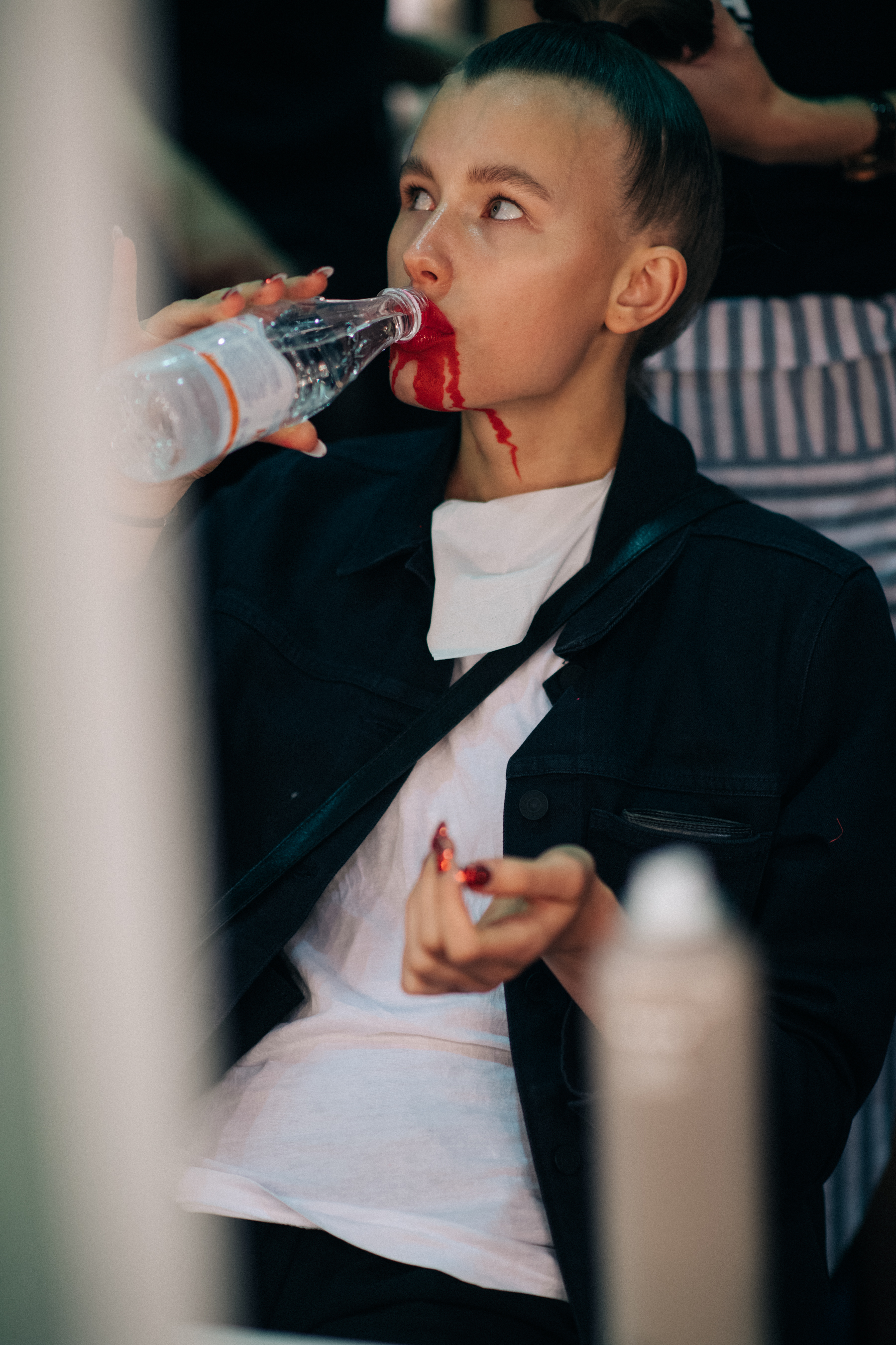 Model in a white top backstage