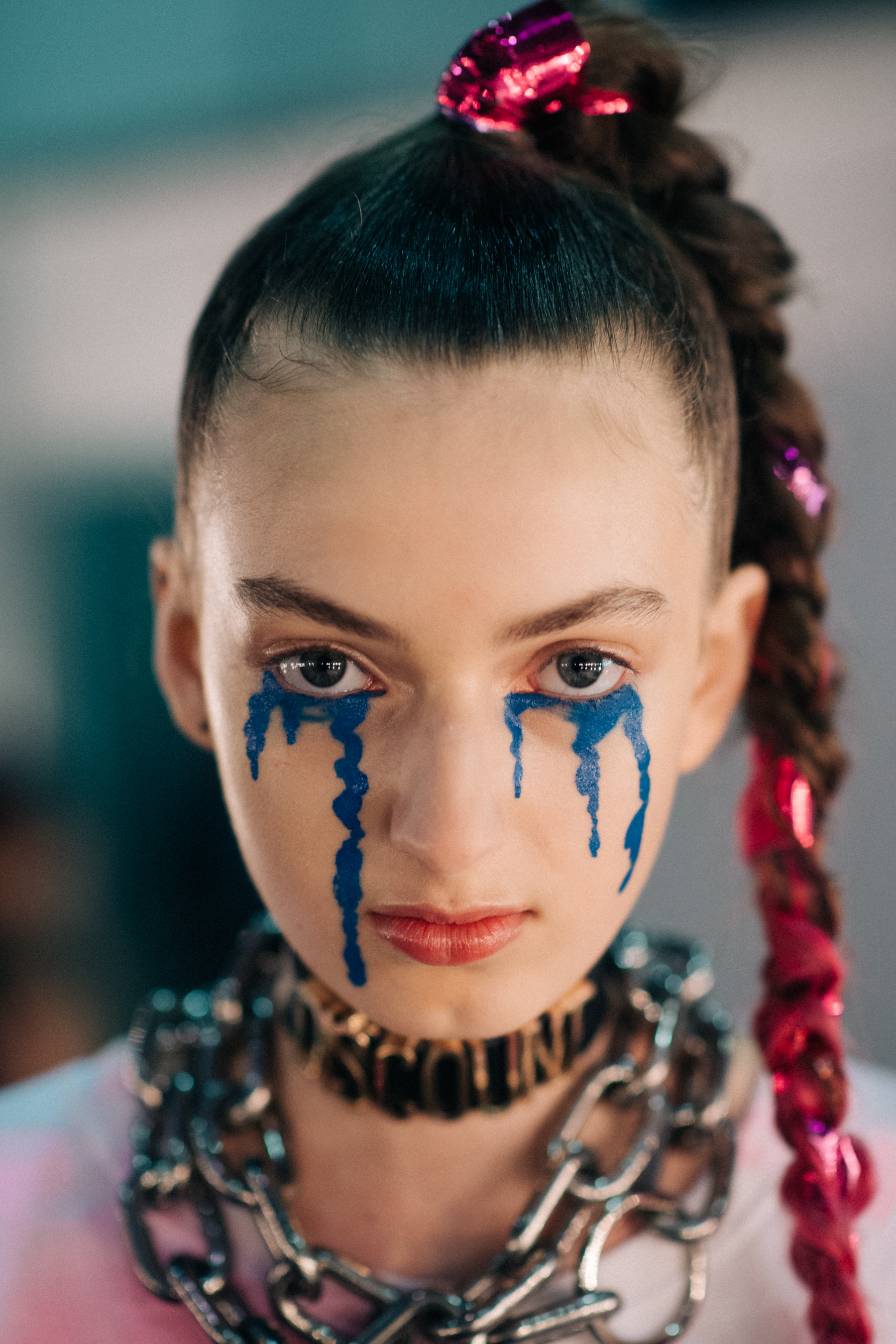 Chains as necklaces, bright blue make-up