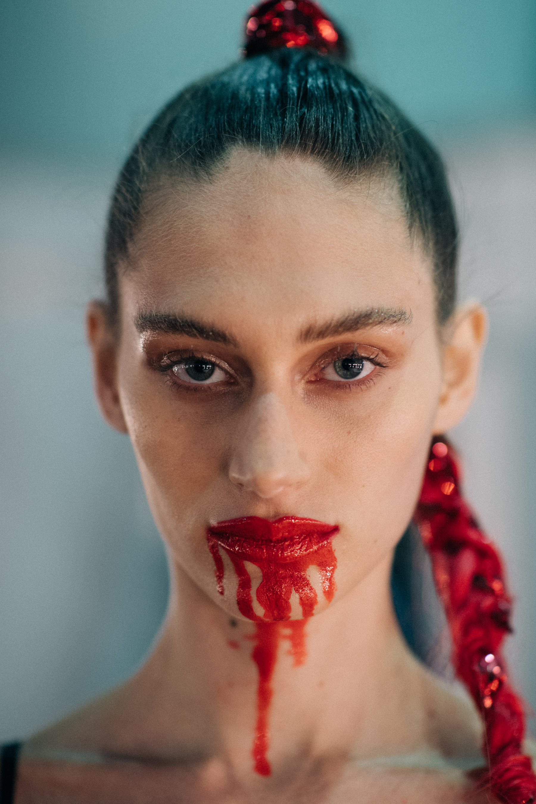 Red glittery braided hair, bold red lips