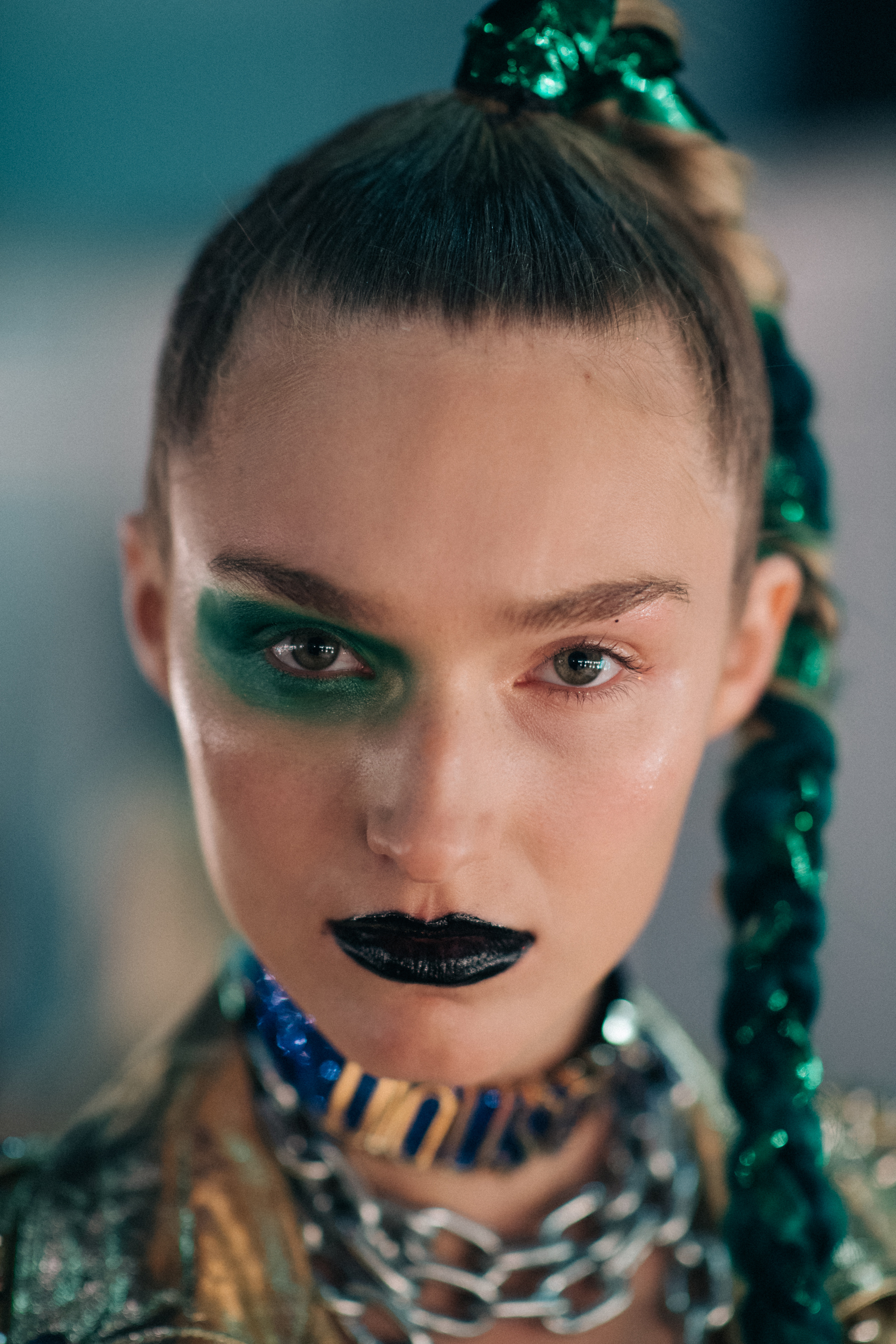 Dark green eye make-up, braided hair