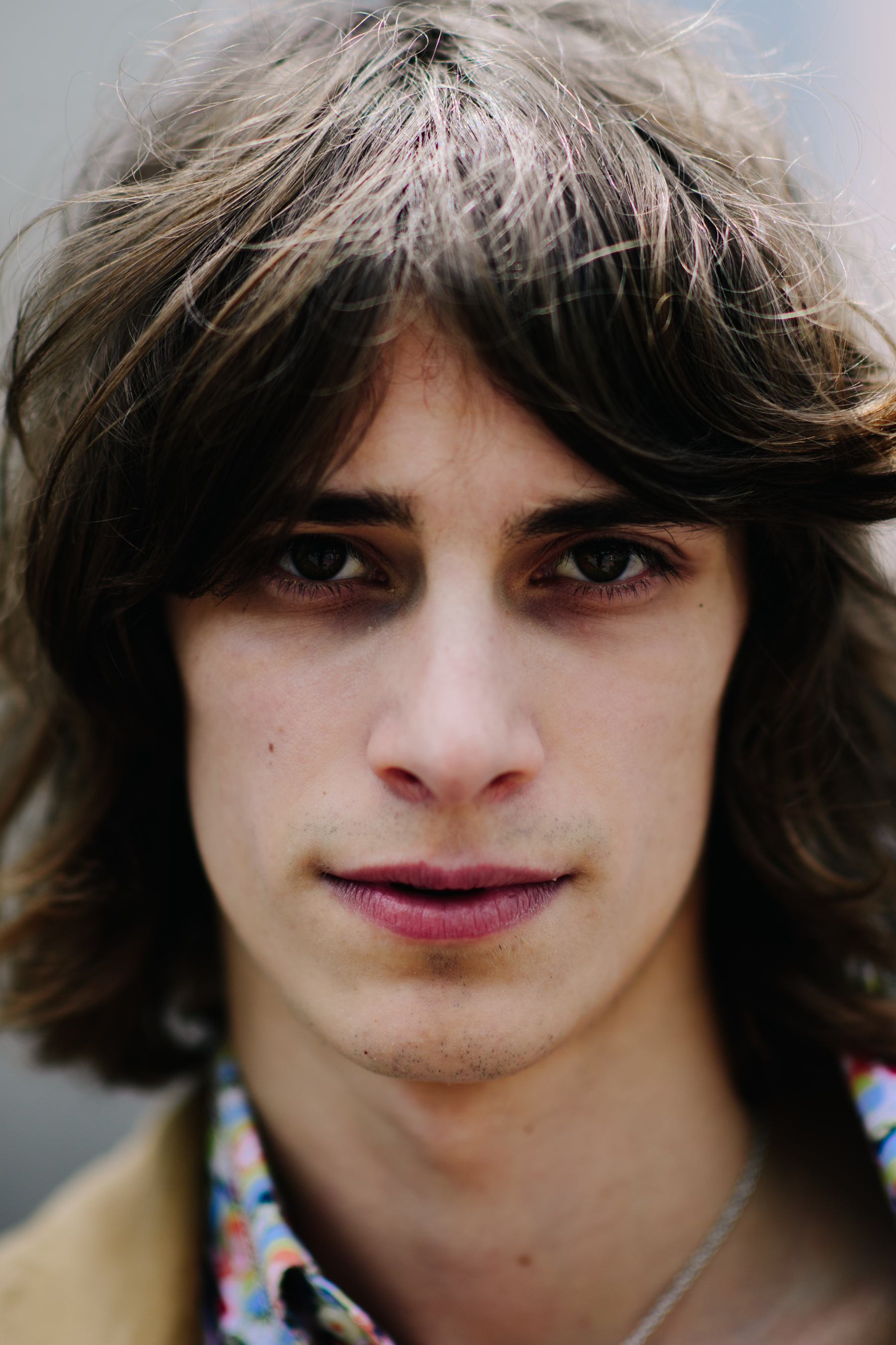 A man with dark long wavy hair