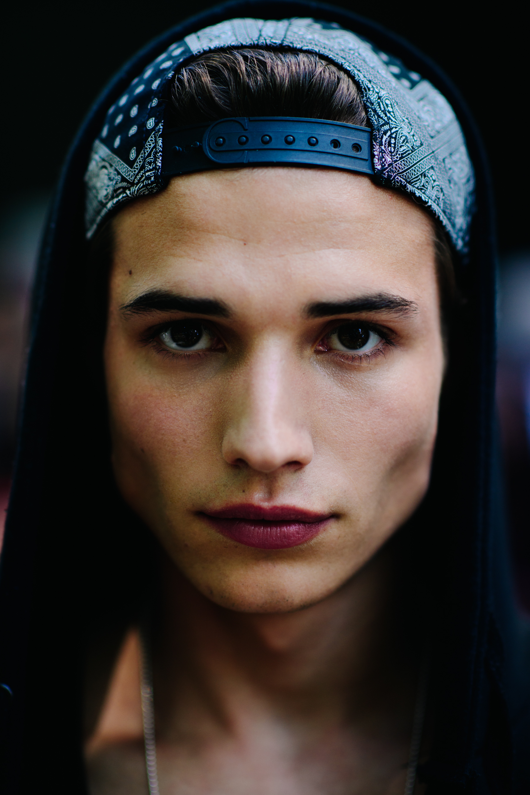 A man with dark hair in a cap