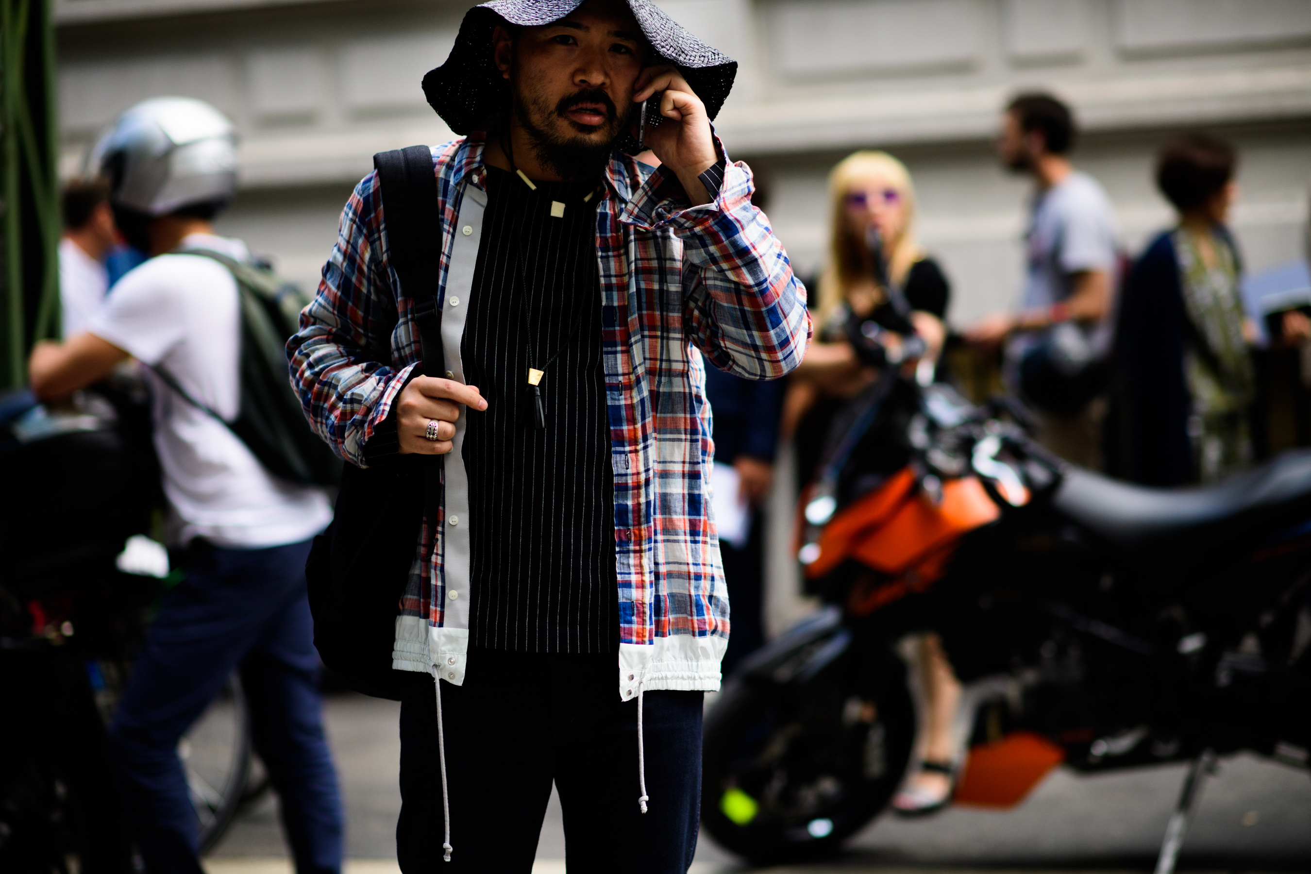 A man in a big hat and a checkered shirt