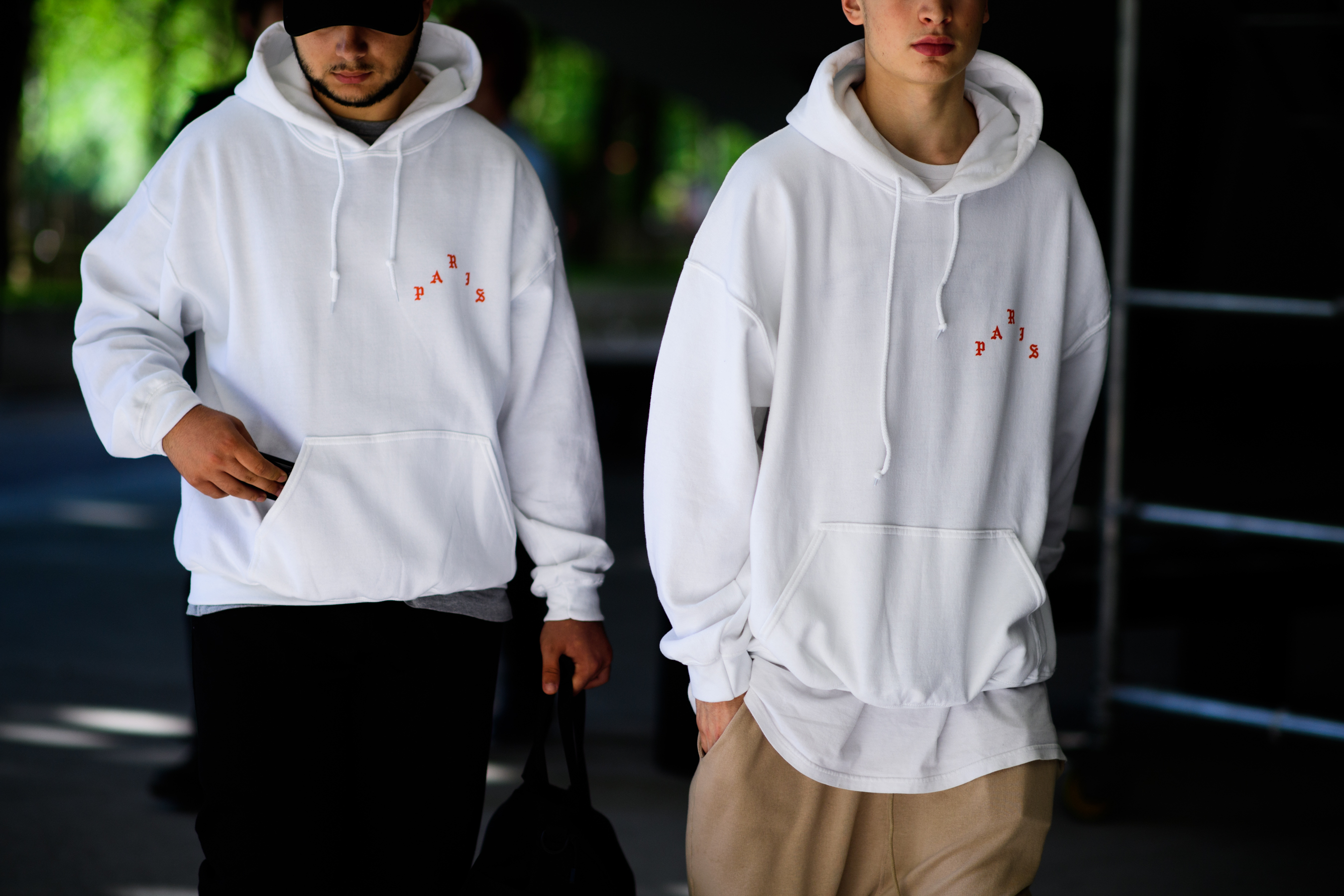 Two men wearing white sweatshirts