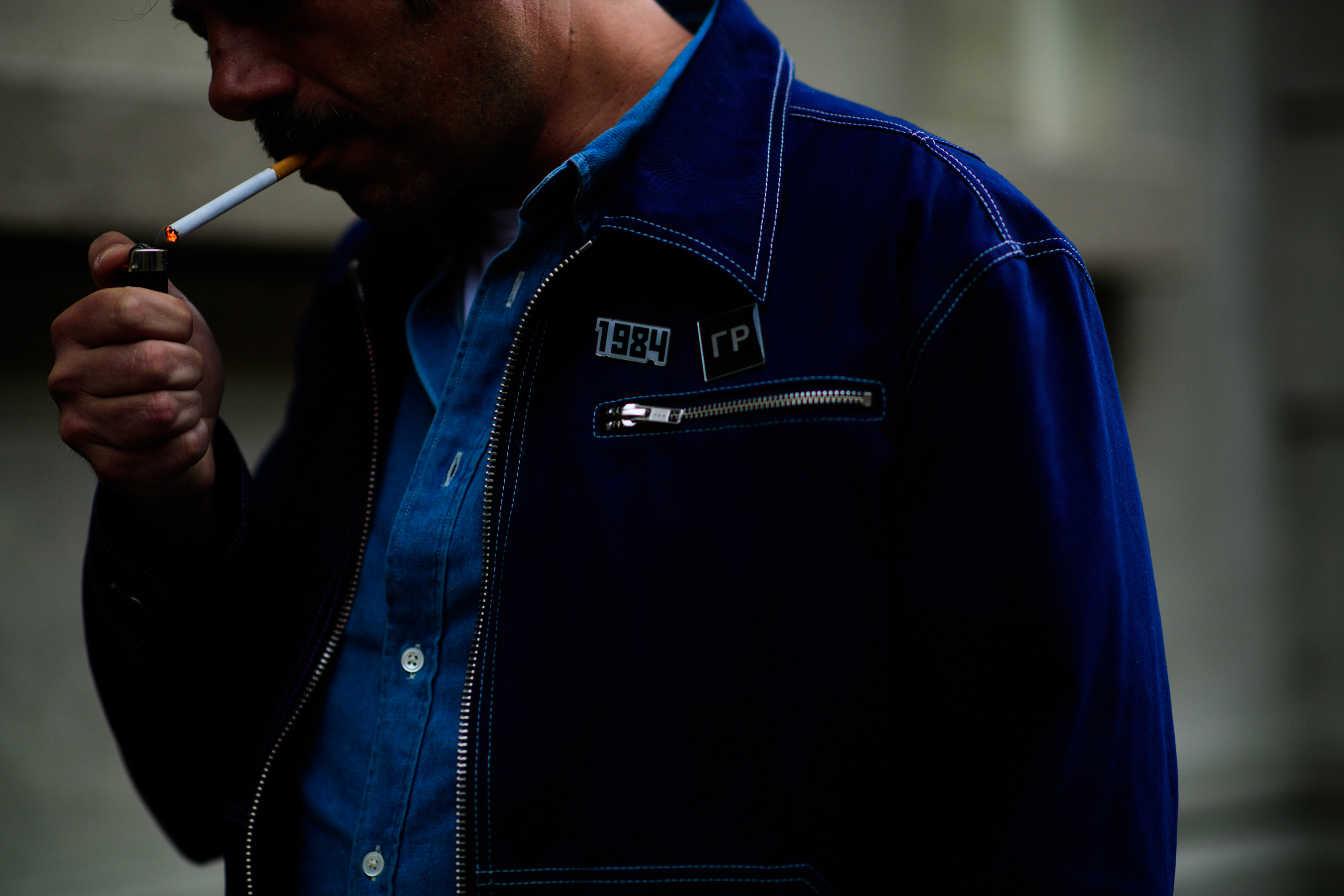 Denim jacket worn over a blue shirt