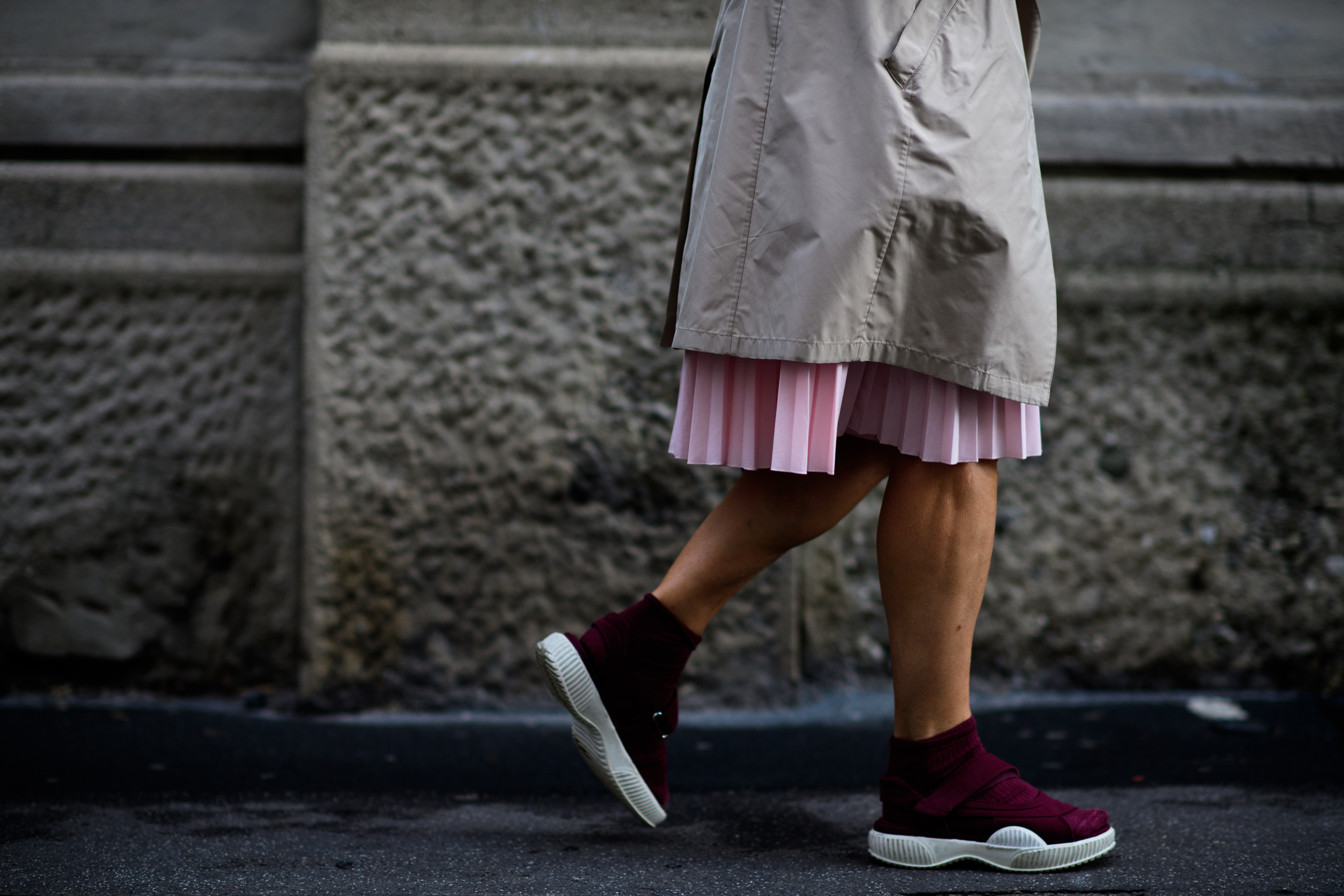 A woman in a pink pleated skirt